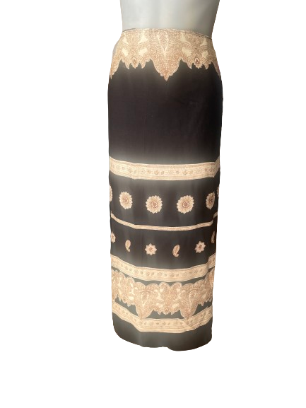 A black wrap skirt with a floral pattern in a contrasting color, displayed on a mannequin.