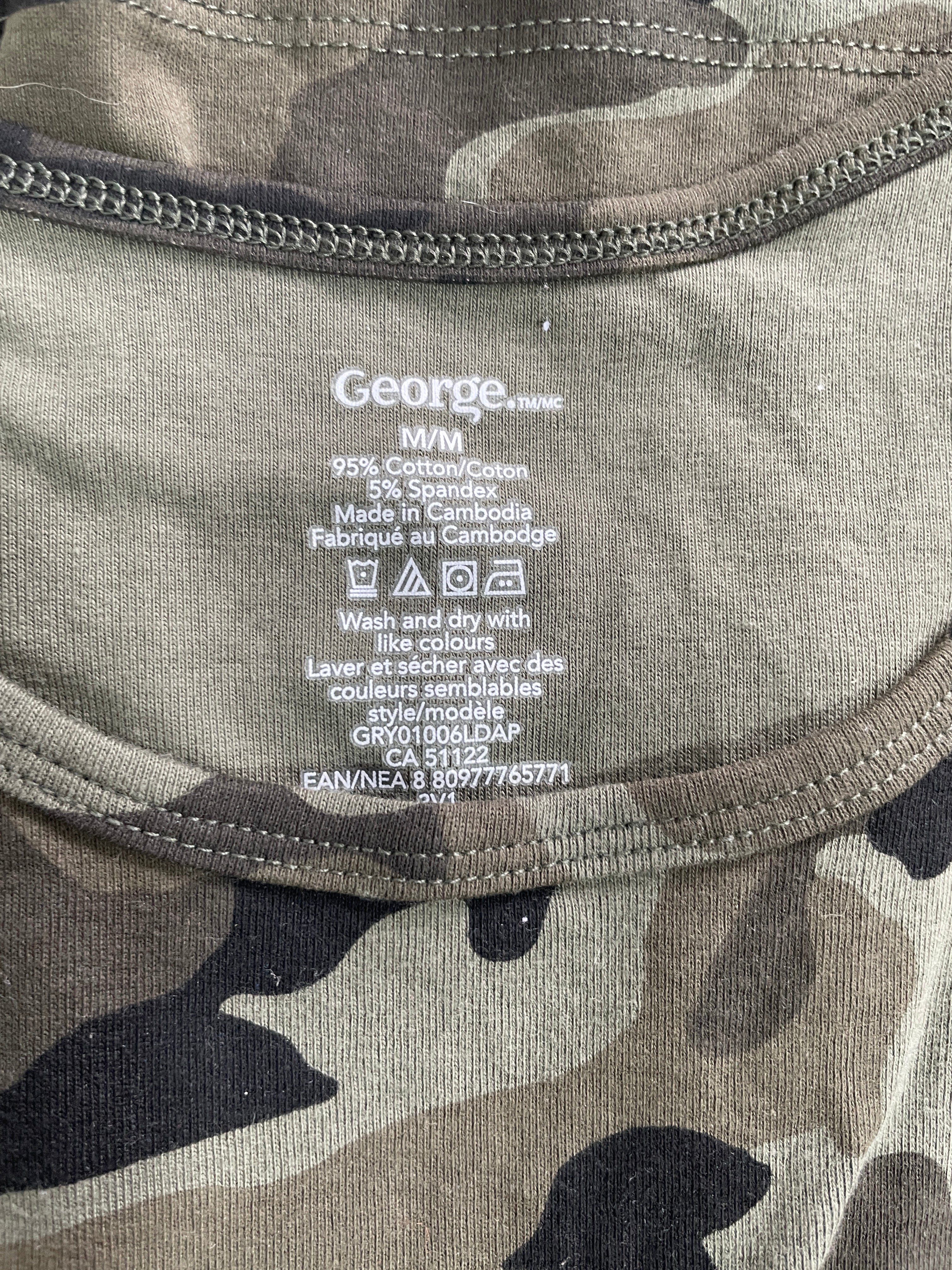 Close-up of the inner neck label of a camouflage t-shirt, showing the brand 'George' and fabric details, with the camouflage pattern visible on the collar.