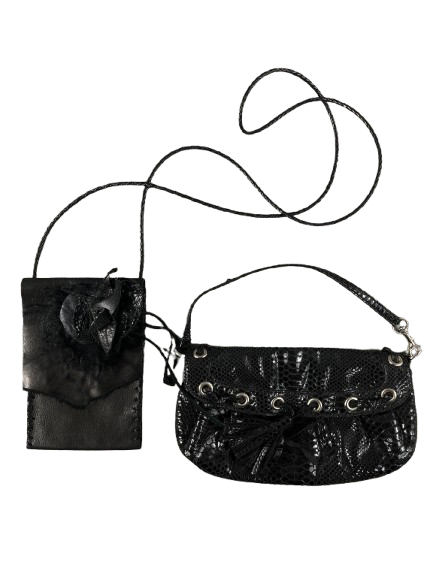 A black Nine West snakeskin look and handcrafted leather evening bag with a wristlet strap and tassels, displayed against a patterned background.
