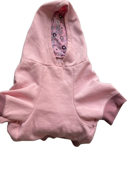 A pink dog sweatshirt with a floral print inside the hood and a leash hole, displayed on a mannequin.
