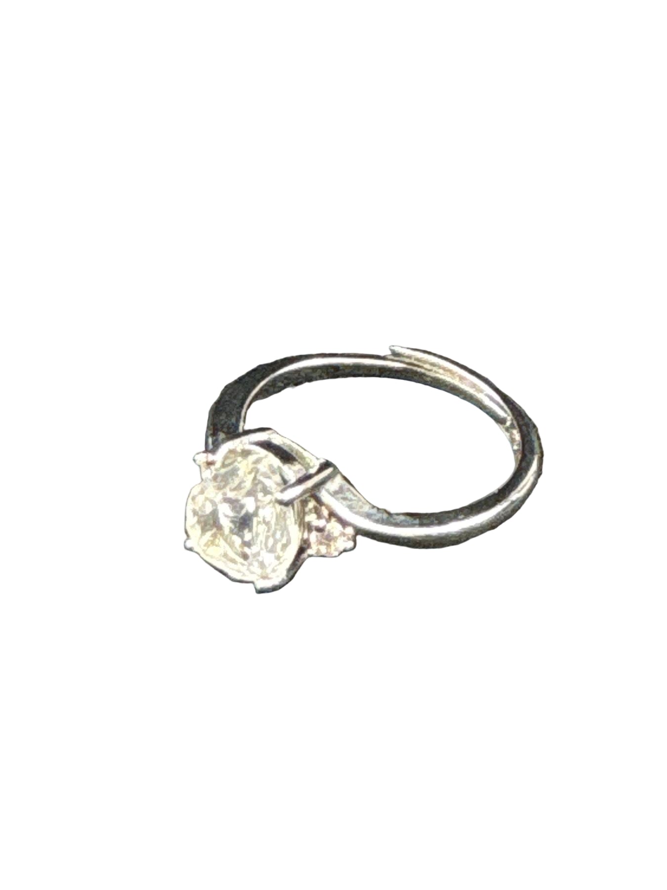 Close-up of oval-cut clear quartz ring with silver tone band