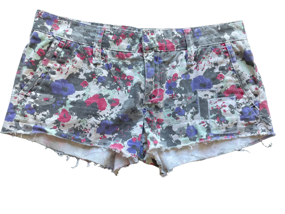 Pair of women's cut-off floral patterned shorts with a frayed hem and pockets.