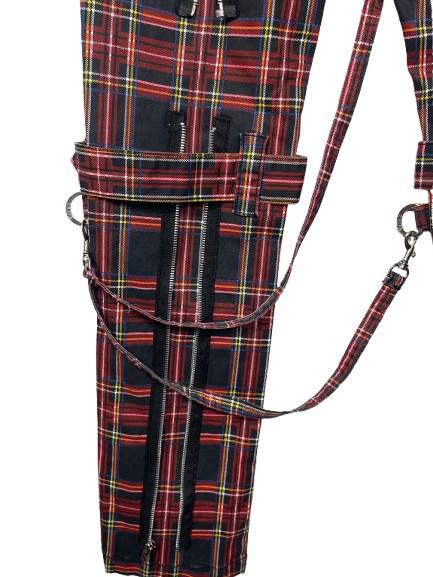 A close-up of a tartan plaid bag or case with multiple zippered compartments and a matching shoulder strap, shown on a plain white background.