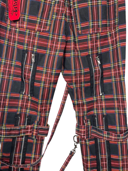 Red and black tartan plaid cargo pants with multiple zippered pockets and a red brand tag near the top left.
