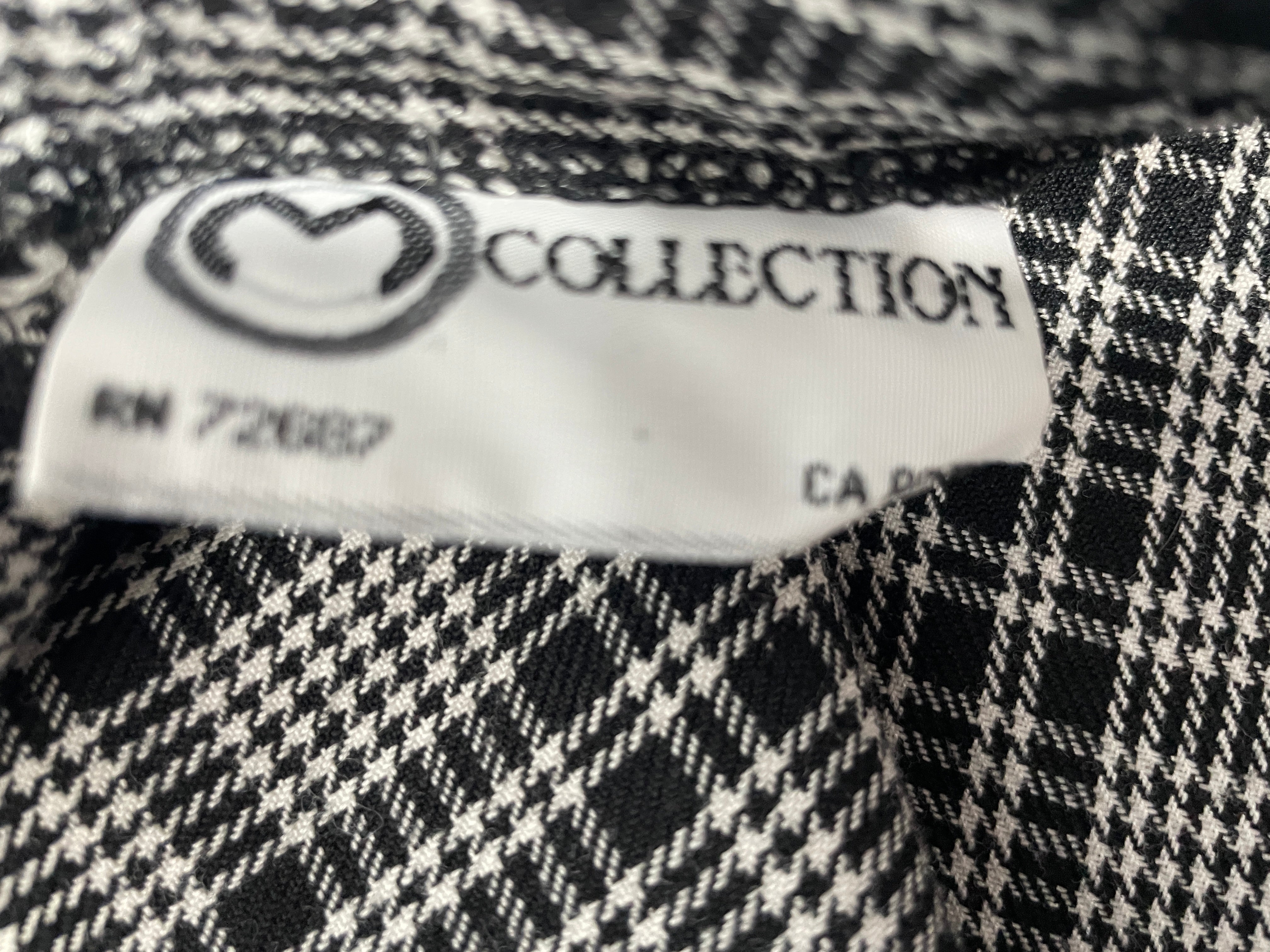 Close-up of a black and white plaid fabric garment showing a white sewn-in label with the brand name COLLECTION and style number RN 72687.