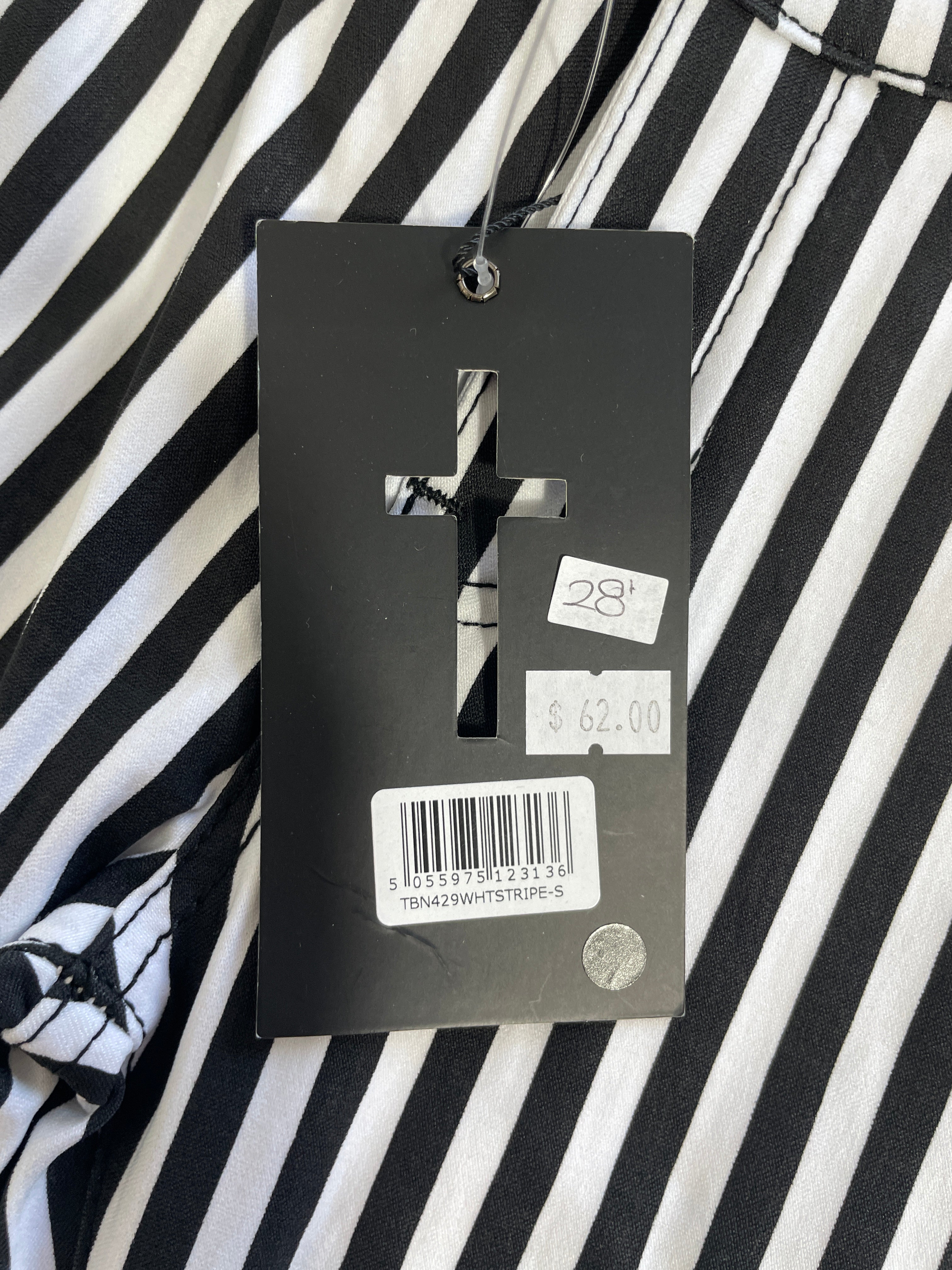 A close-up of a black and white striped garment with a black hangtag attached. The tag has a cross-shaped cutout, a barcode, and two price stickers showing $28 and $62.