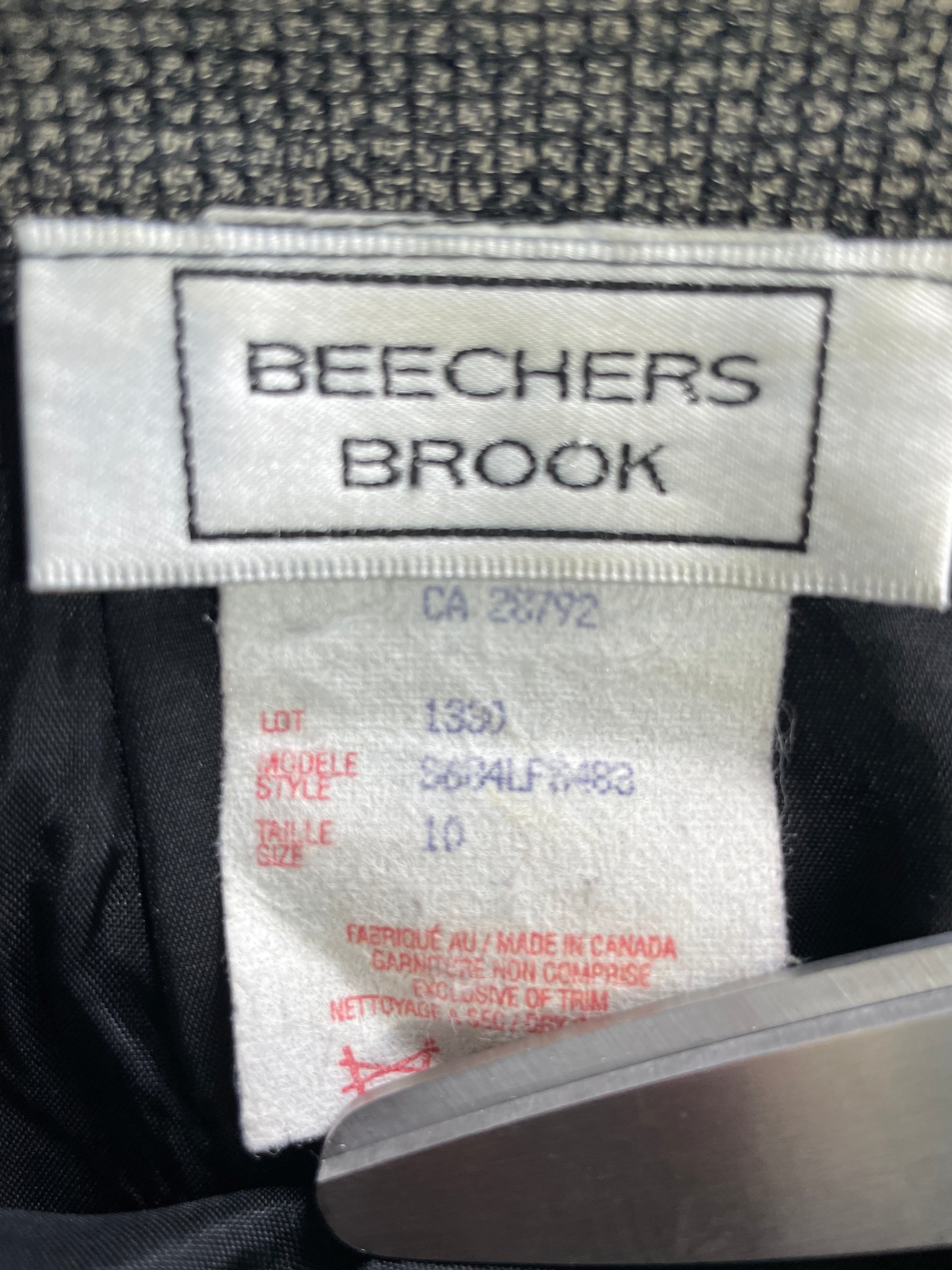 Close-up of a clothing interior label reading BEECHERS BROOK, with size and lot information printed below on a white fabric tag.