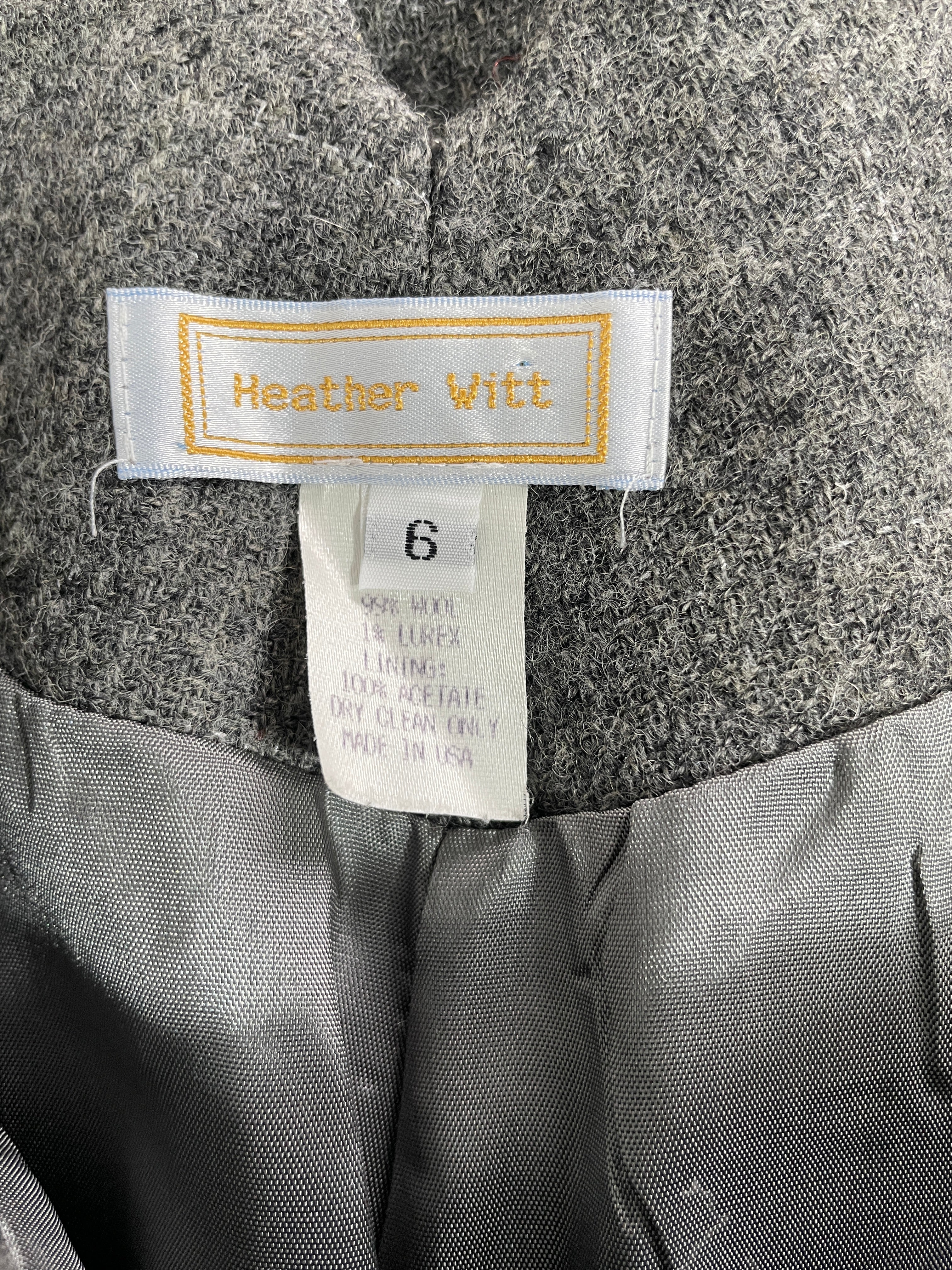 Close-up of a gray textured garment interior with a visible Heather Witt brand label and a size 6 tag.