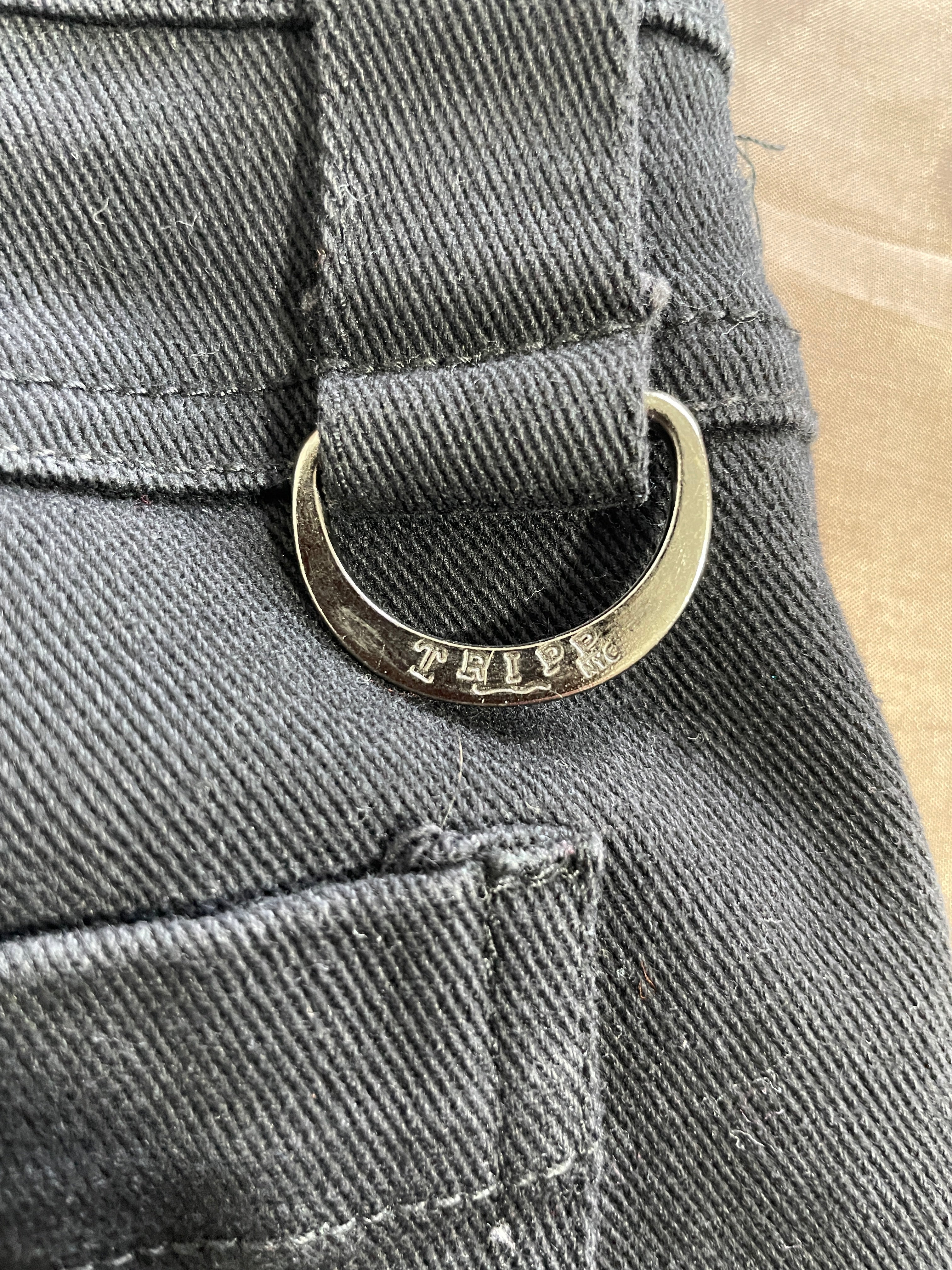 Tripp NYC black pants silver-tone engraved D-ring hardware close-up