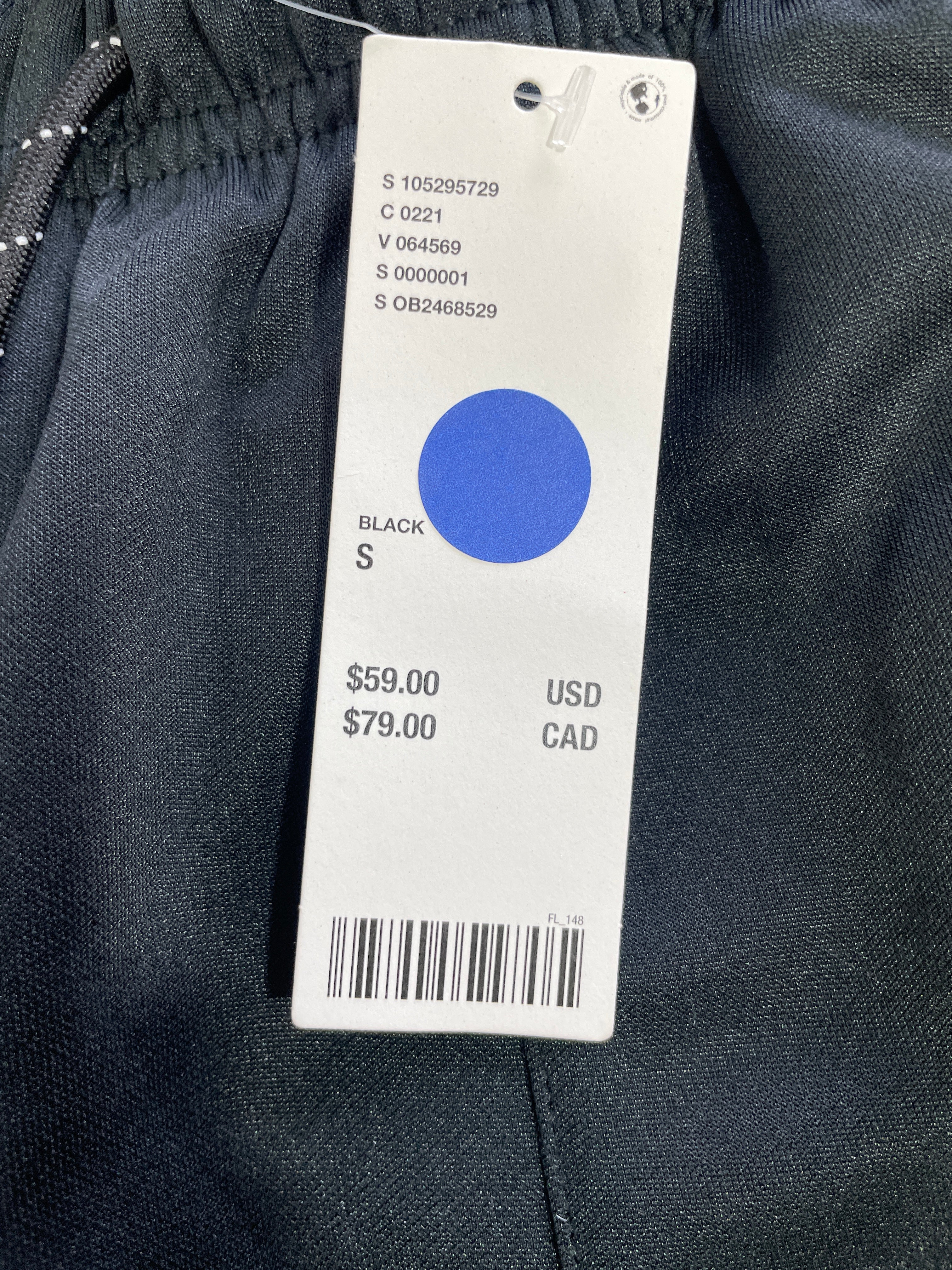Urban Outfitters original retail tag showing $79 CAD black track pants size Small