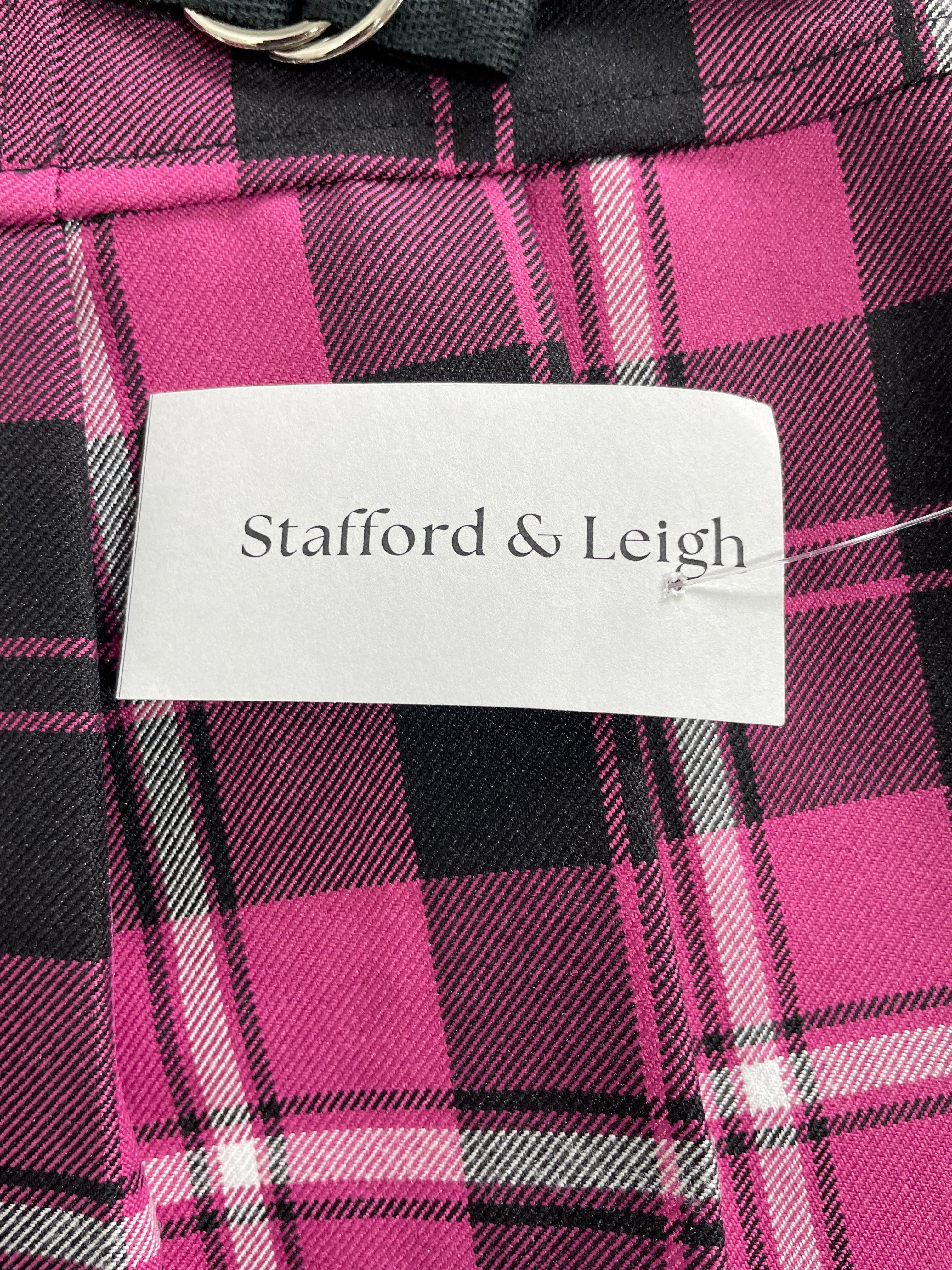 Close-up of a pink, black, and white plaid garment with a visible white paper label reading 'Stafford & Leigh'.
