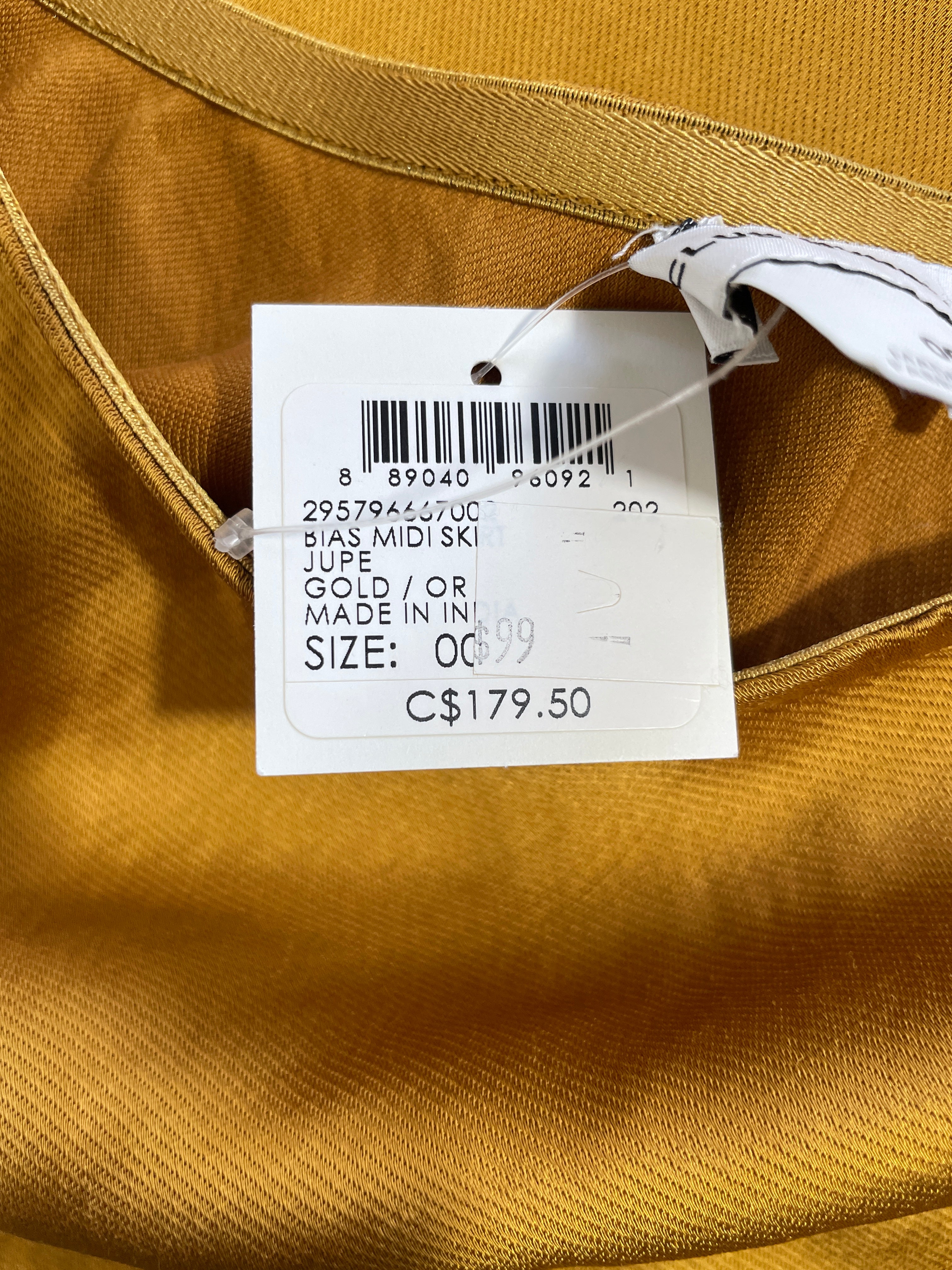 Club Monaco gold midi skirt original retail tag showing brand and product information