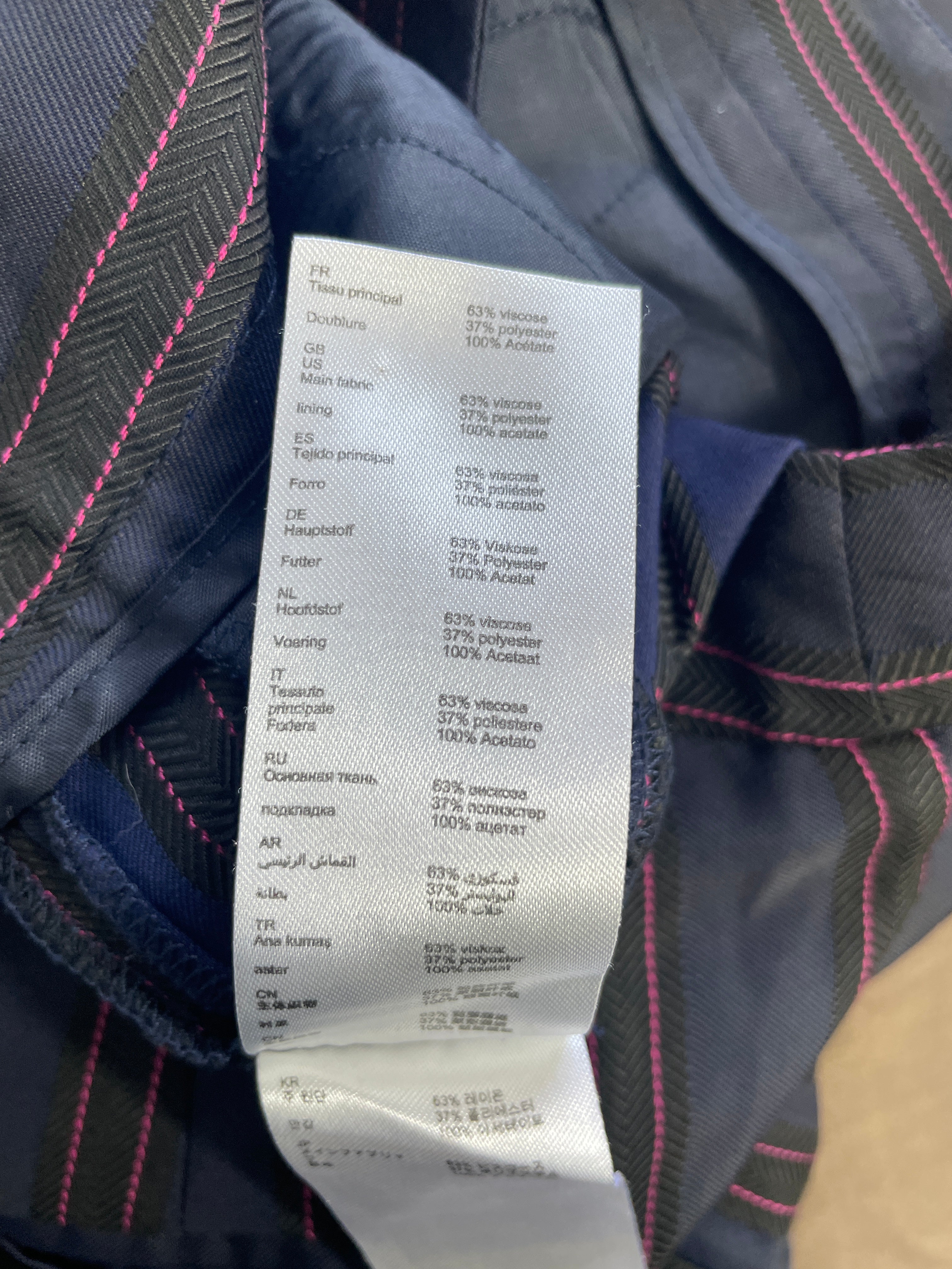 Fabric composition label showing 63% viscose 37% polyester and acetate lining