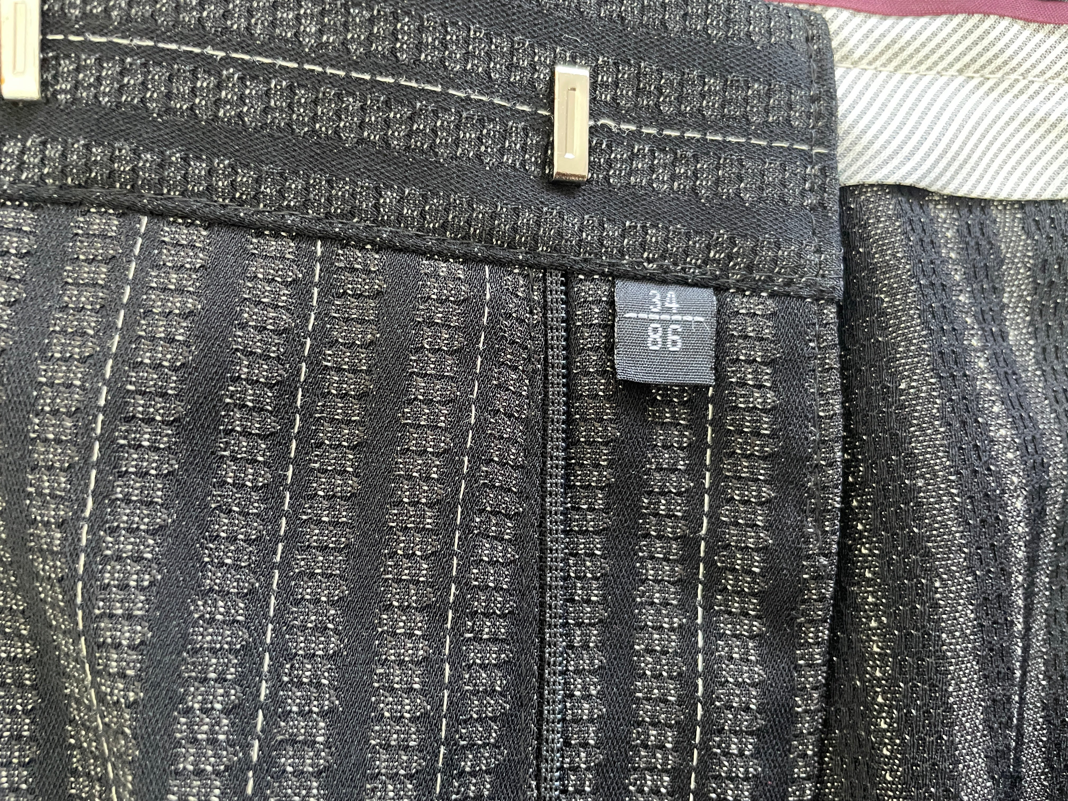 Close-up of Nino Mantelli men's trousers size 38 tag and textured stripe fabric
