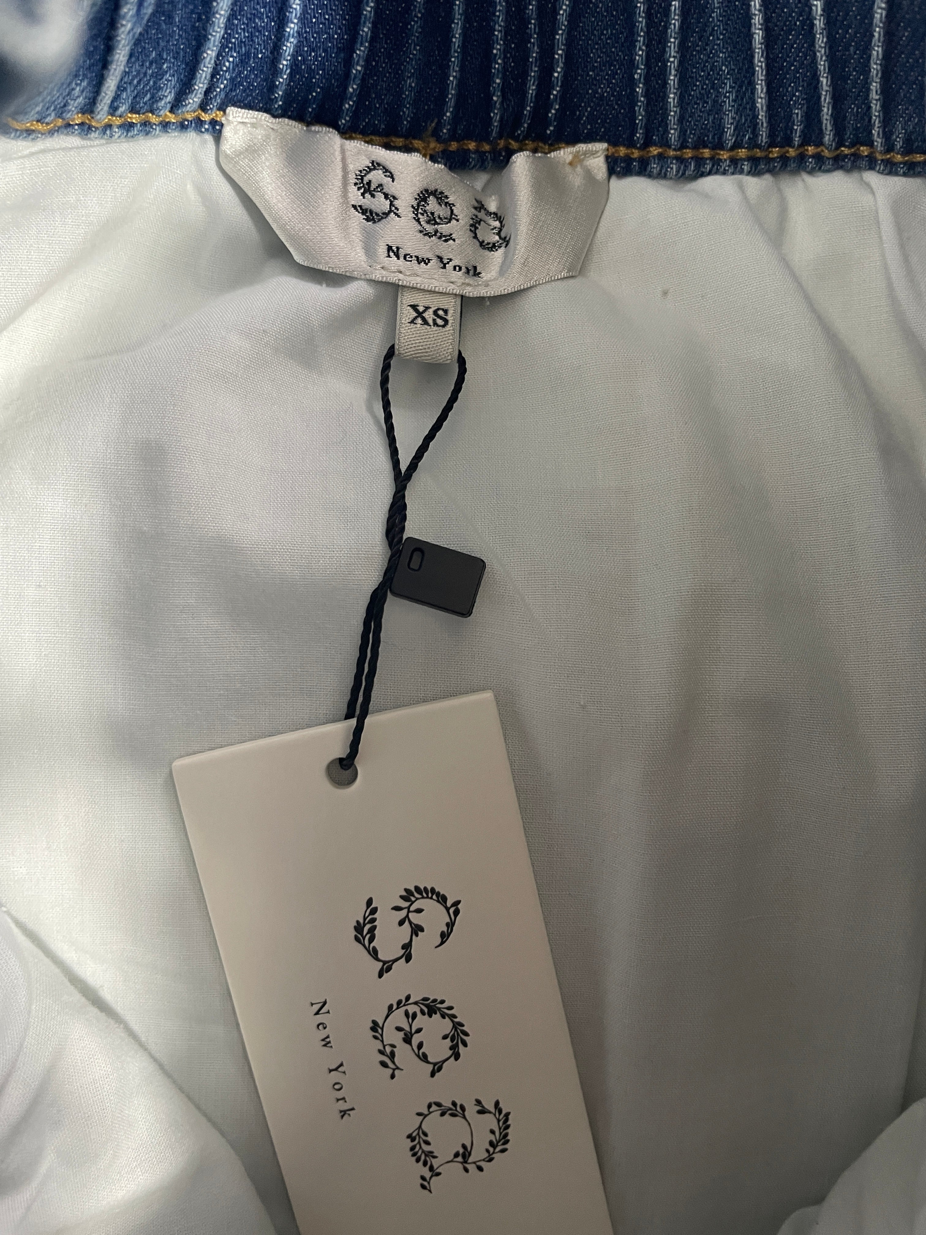 Sea New York designer label and XS size tag inside blue denim skirt