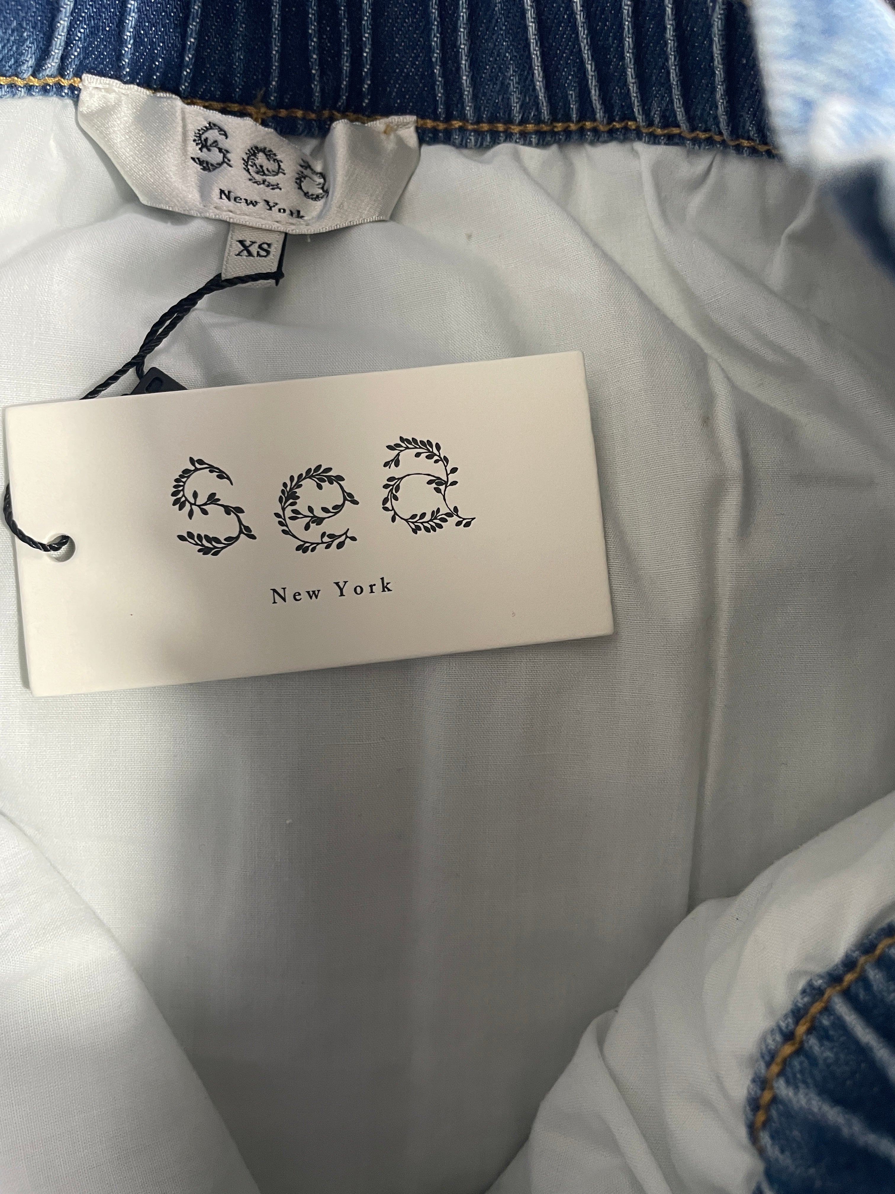 Sea New York branded hangtag attached to quilted denim mini skirt