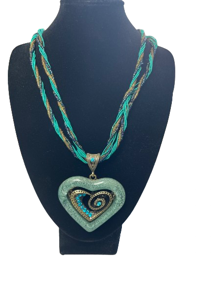 Necklace with a heart-shaped pendant on a black mannequin bust