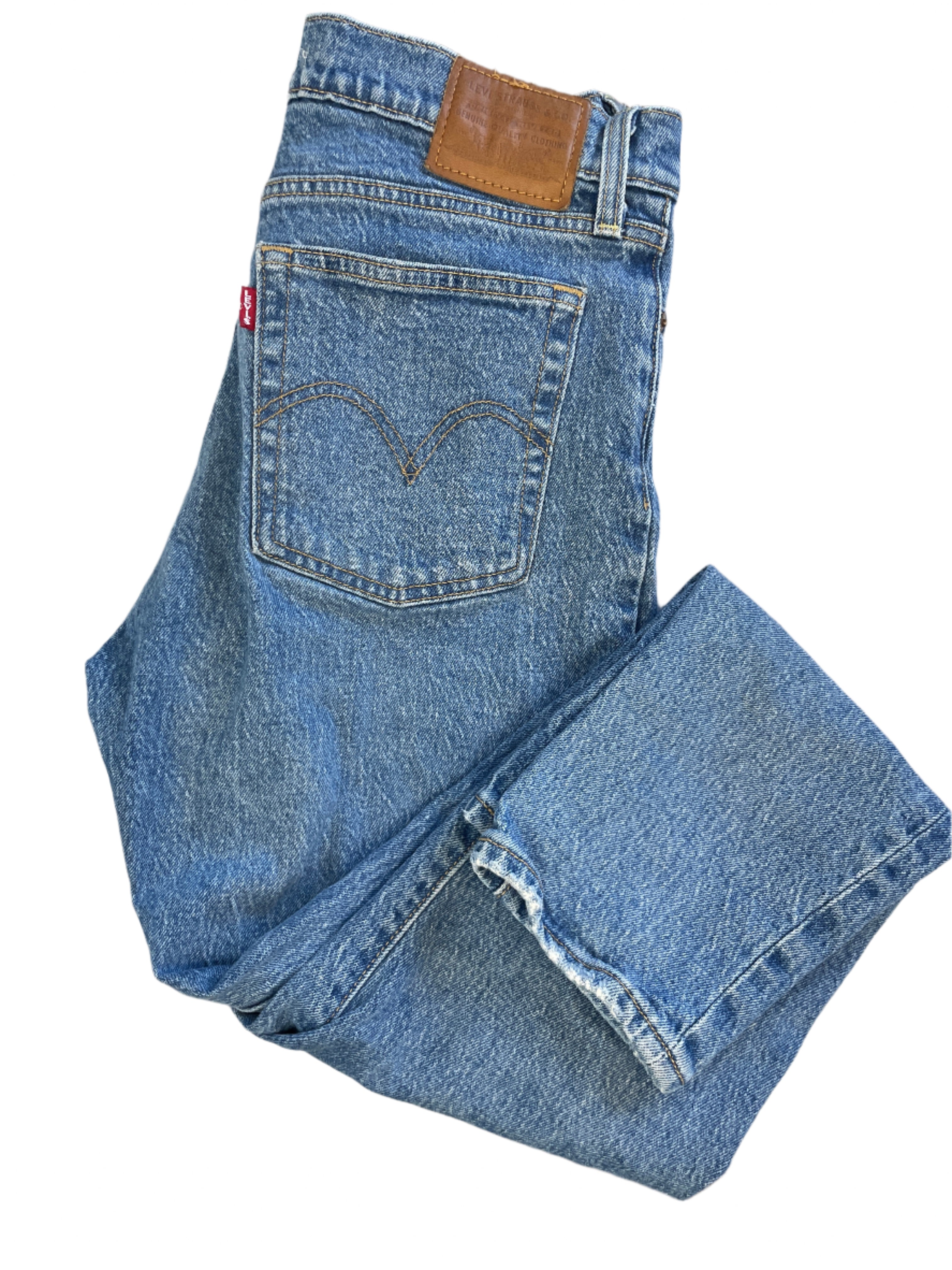 Levi’s Wedgie women’s jeans, medium wash, button fly, back leather patch, size 28, folded for display on white background.
