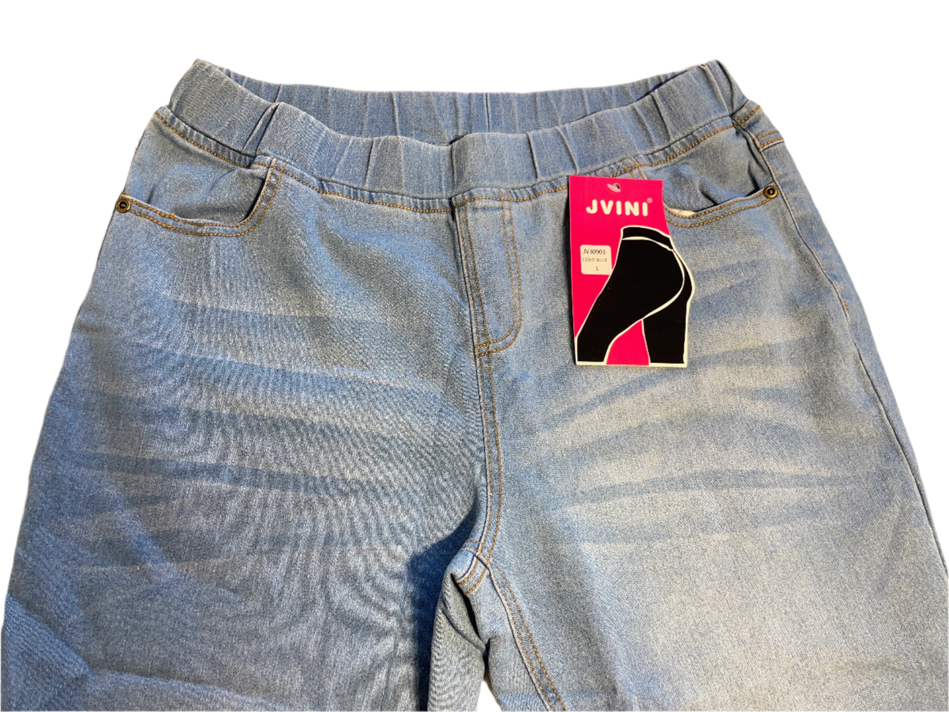 Light blue jeans with a Jvini tag on a white surface