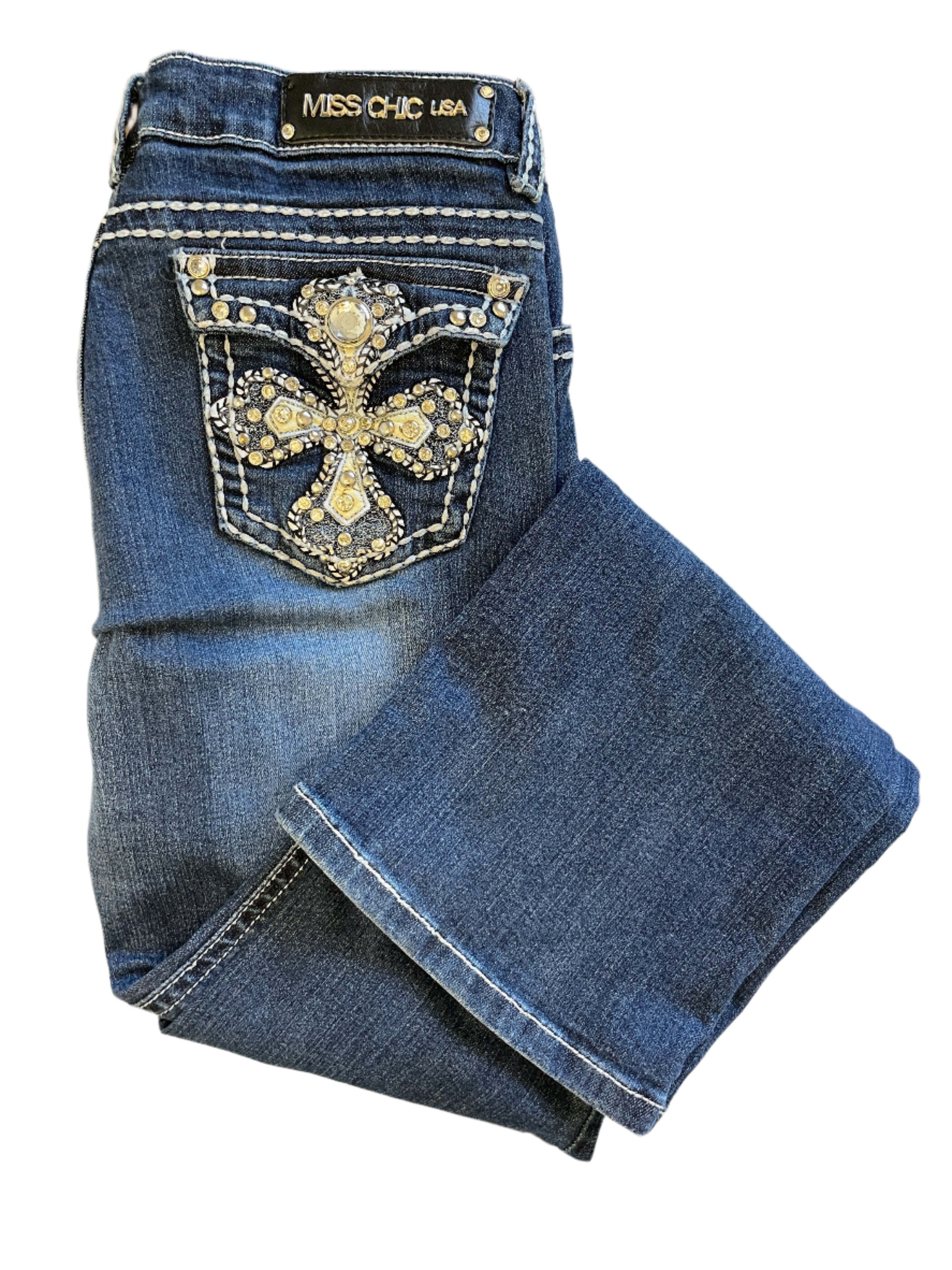 Folded Miss Chic bootcut jeans showing embellished rhinestone cross pocket