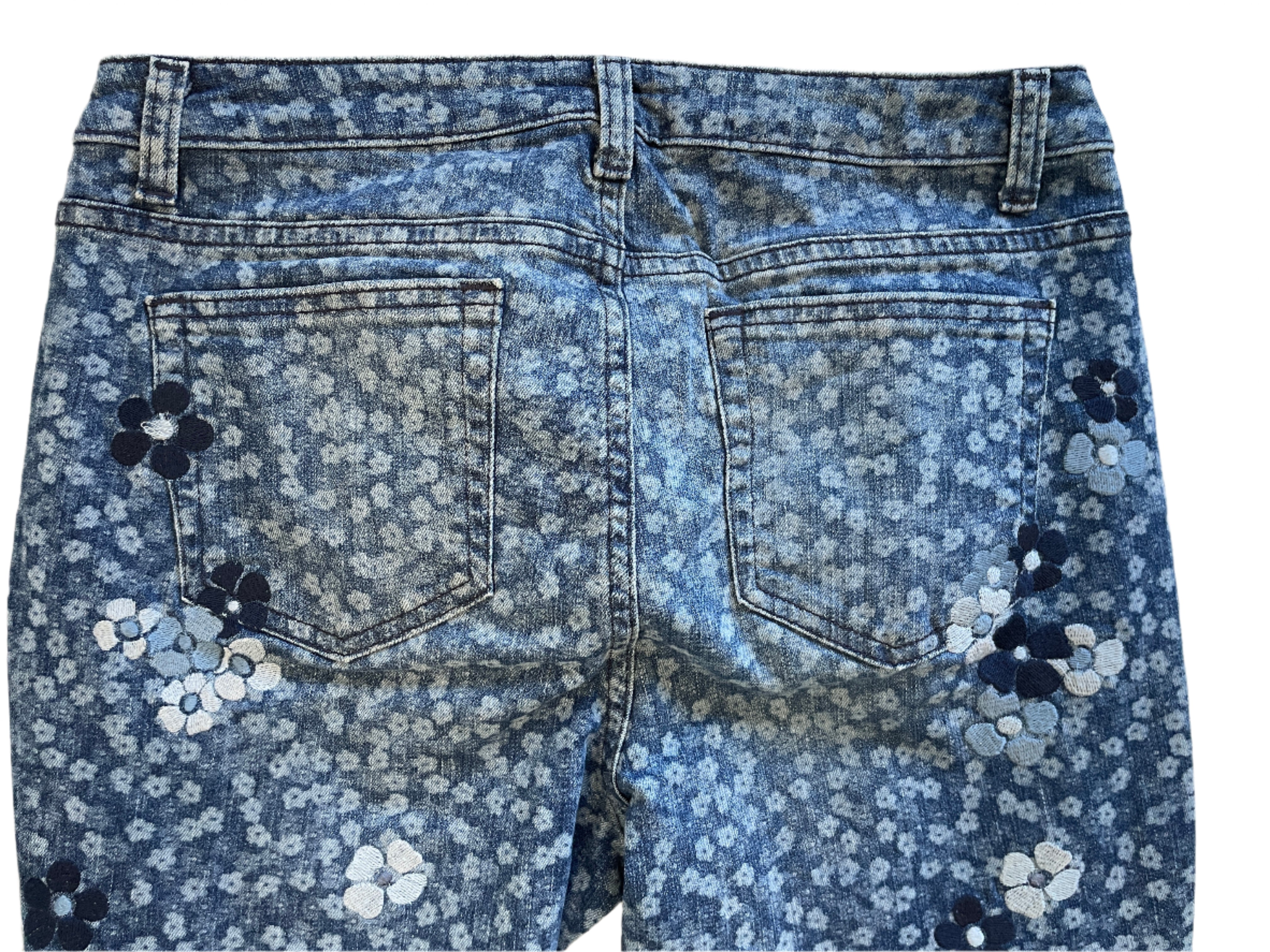 Blue floral-patterned jeans on a white background
