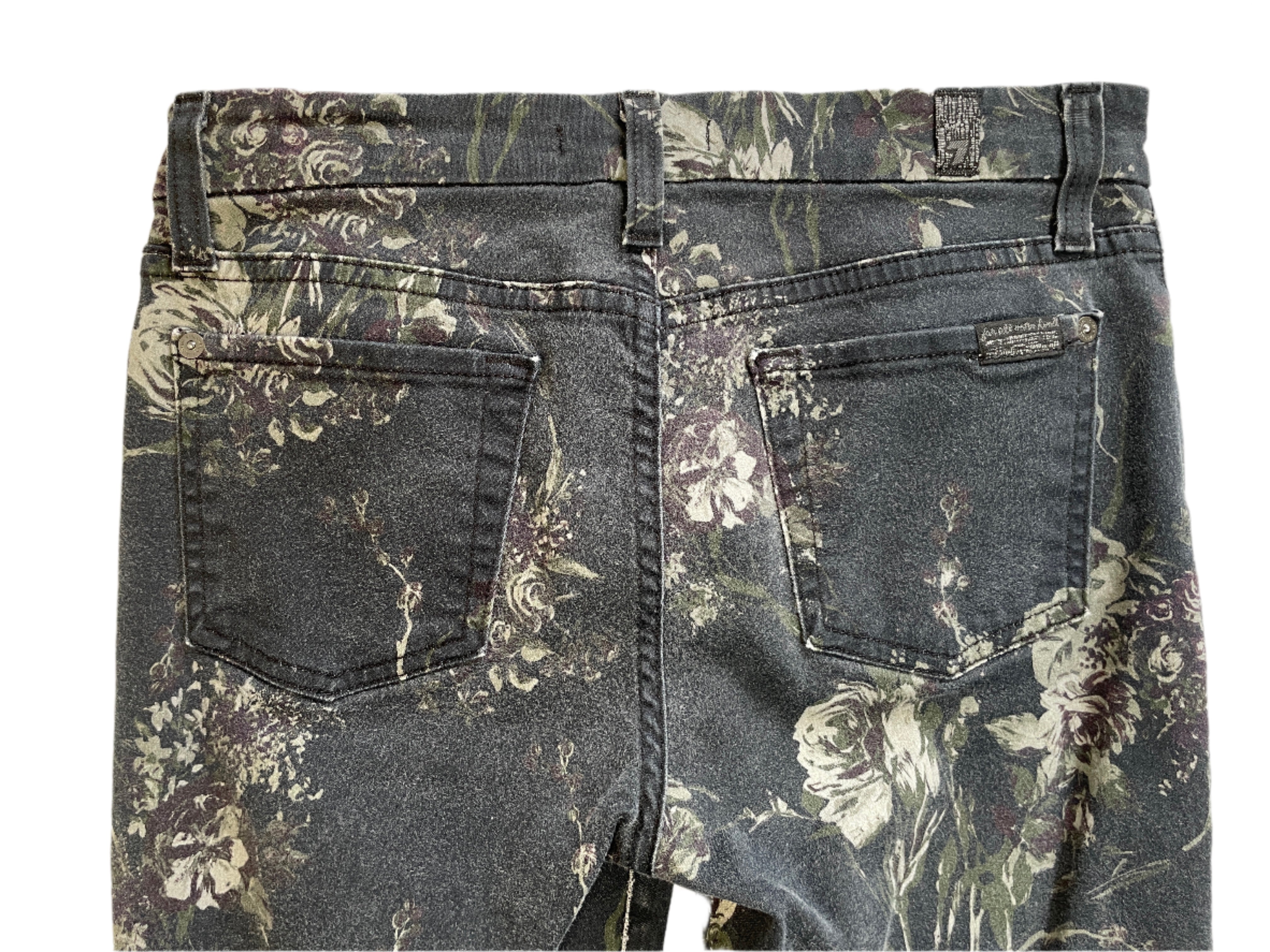 Floral-patterned jeans on a plain background