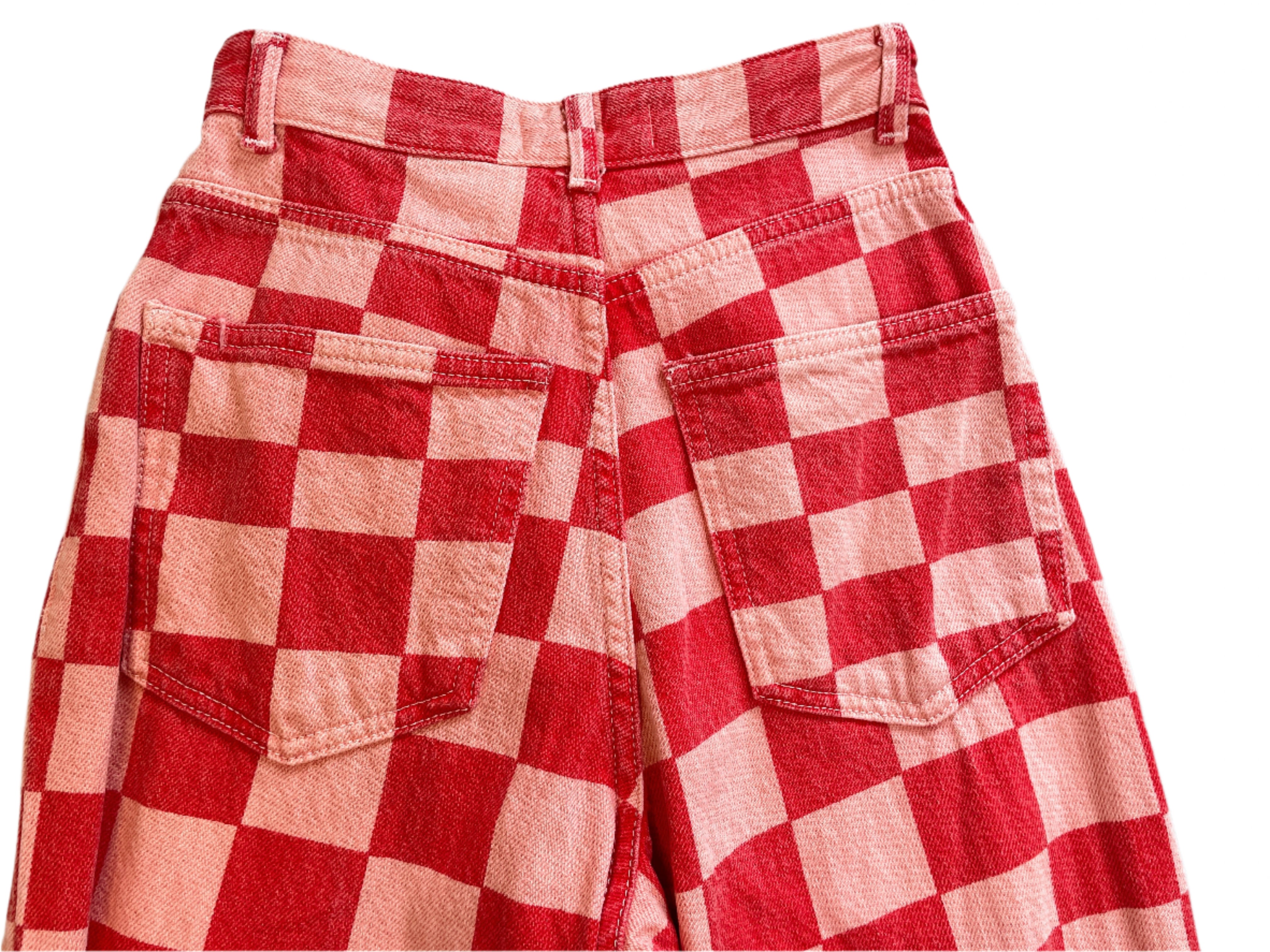 Red and white checkered jeans on a light gray surface
