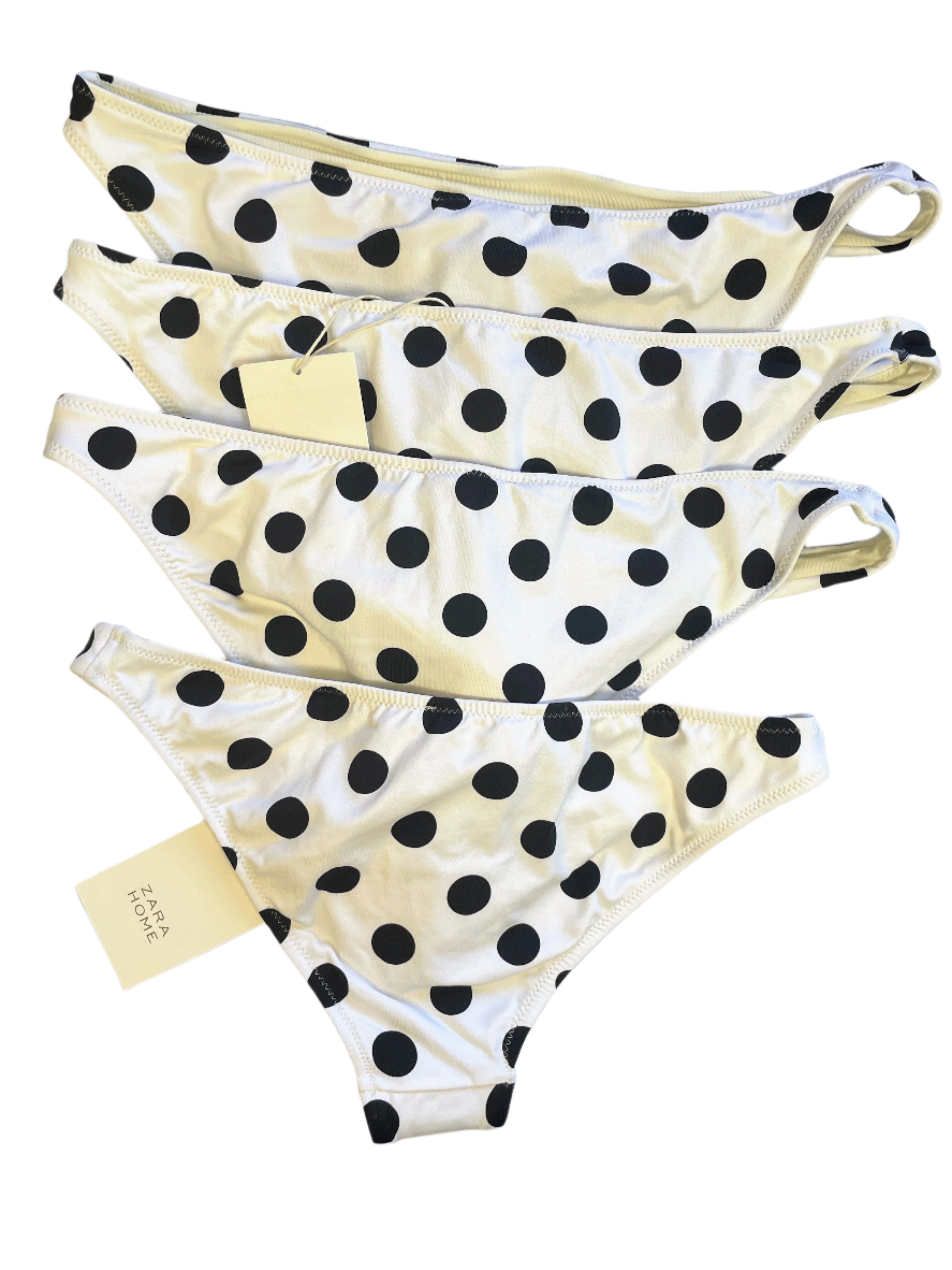 Set of polka dot bikini bottoms on a light gray surface