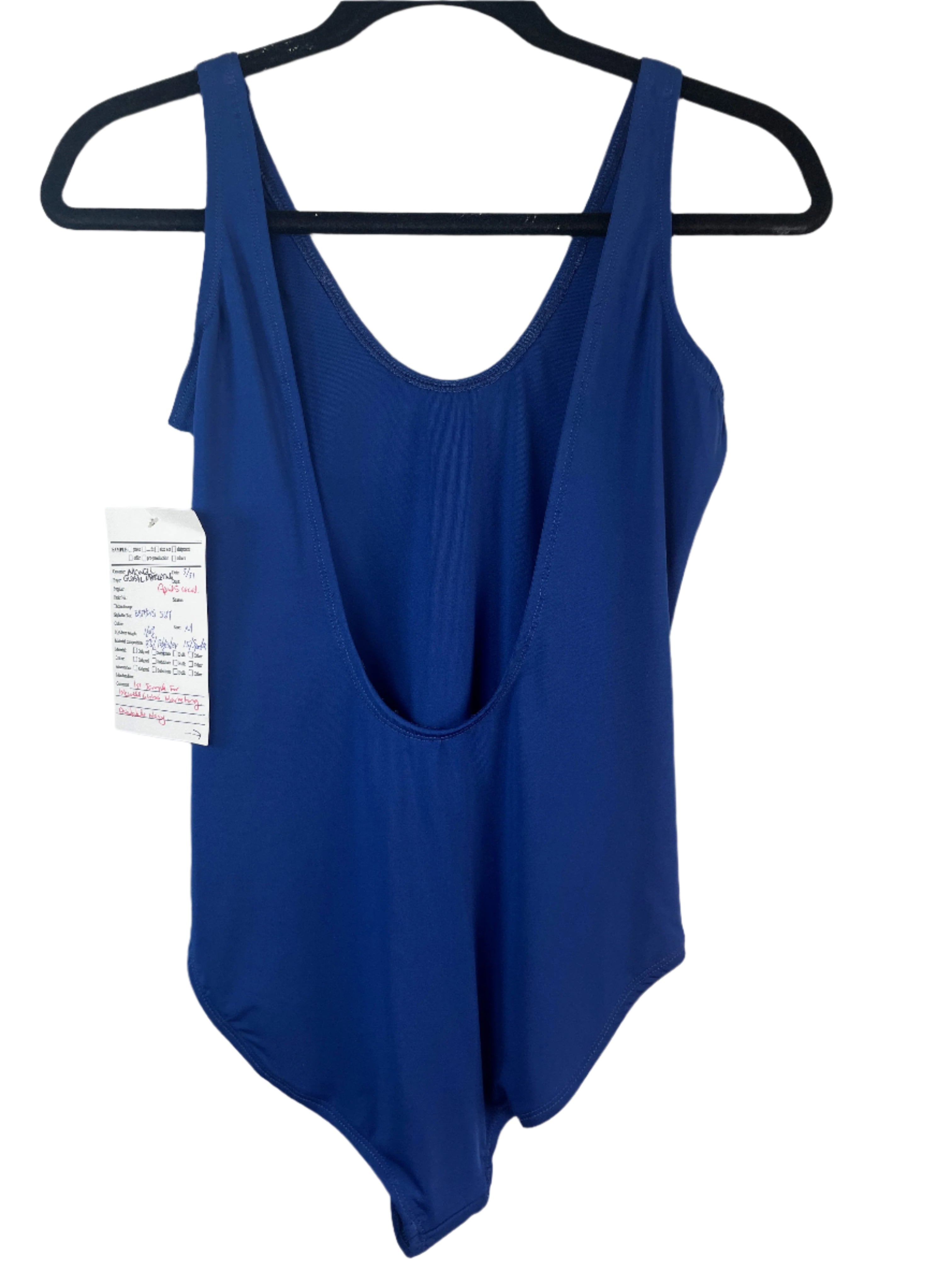 Blue swimsuit on a hanger with a white background