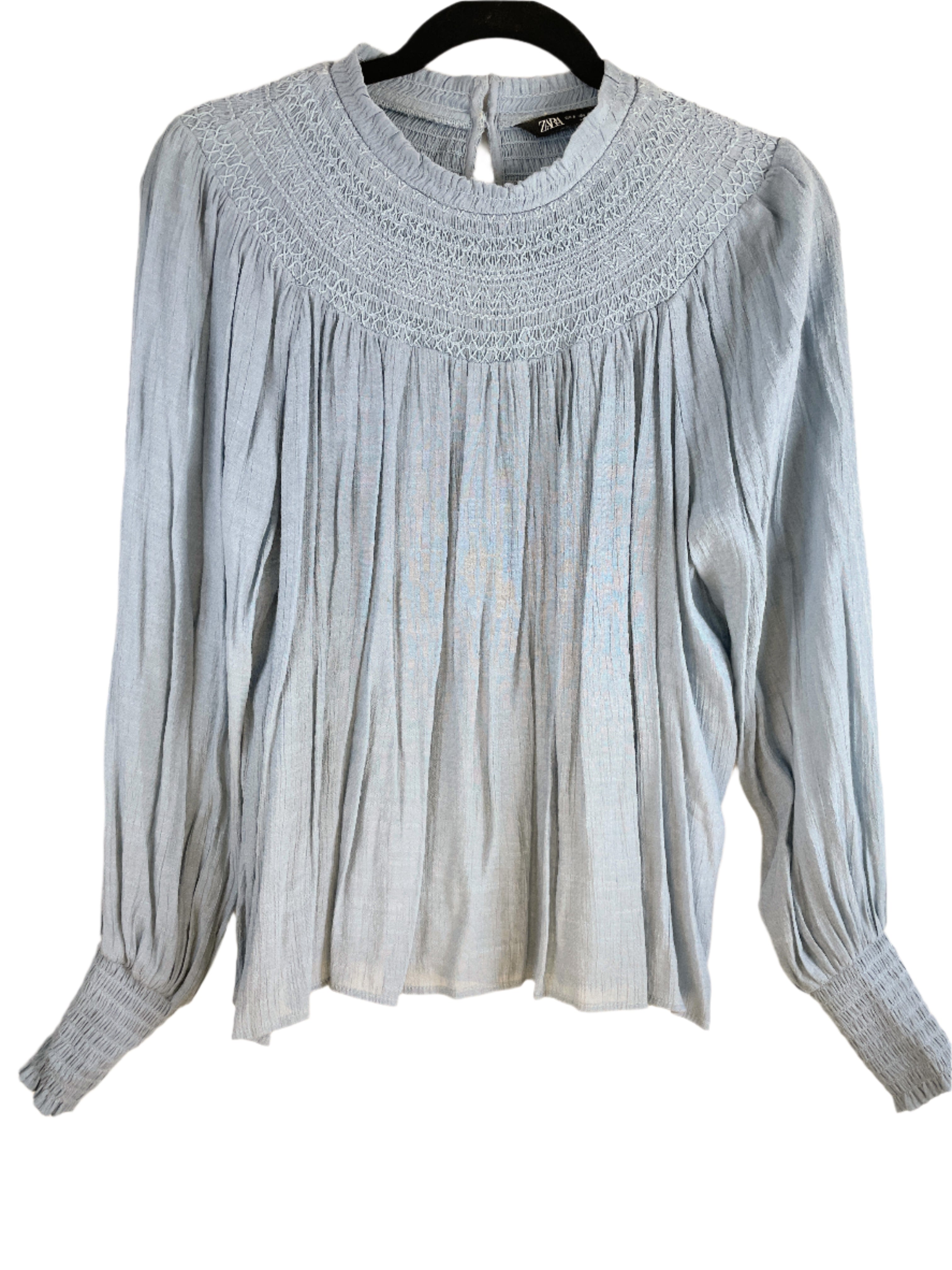Front view of Zara blue smocked yoke blouse, long sleeves, size small.
