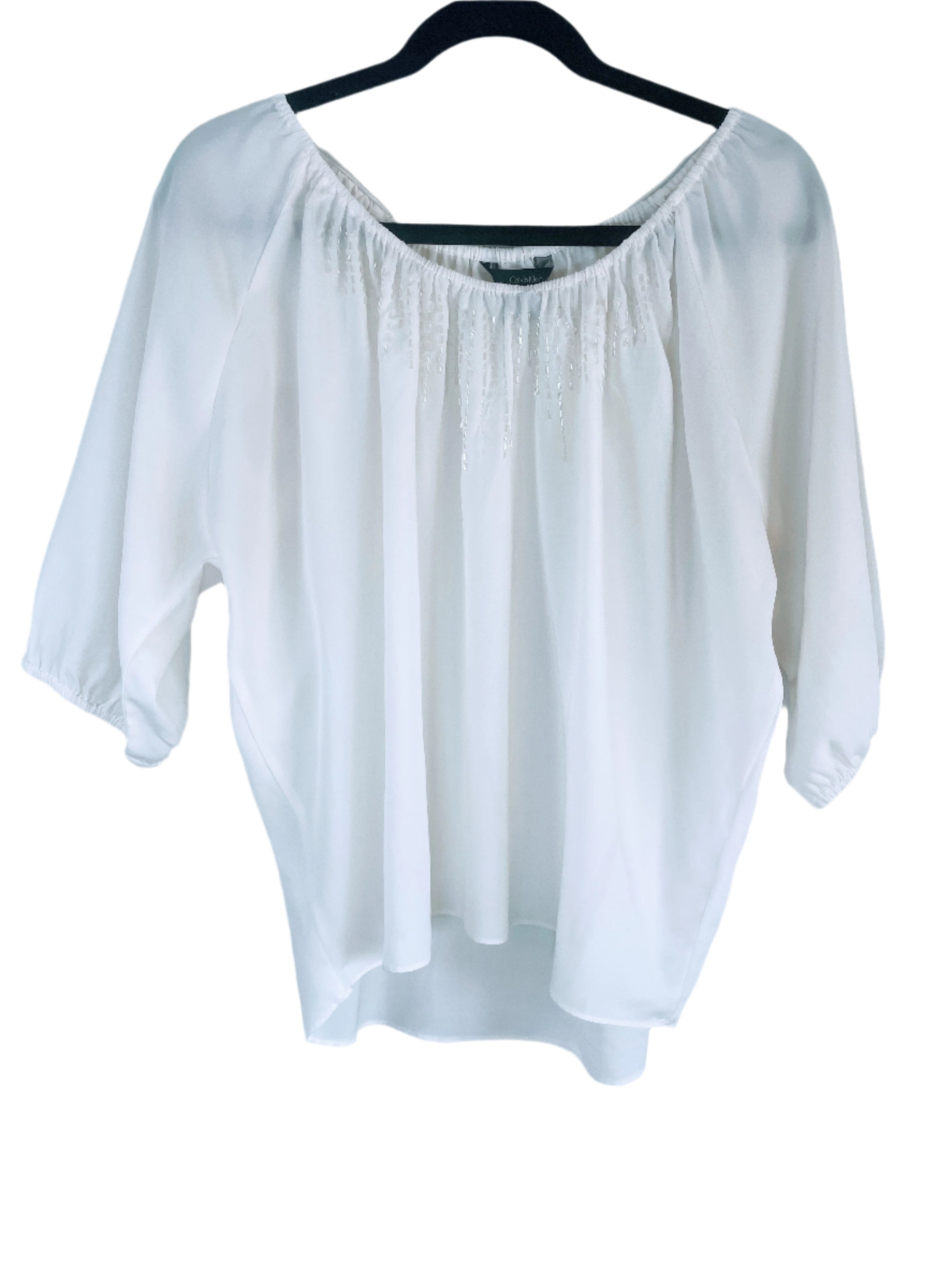 Front view of Calvin Klein Jeans cream blouse with beaded accents, size medium