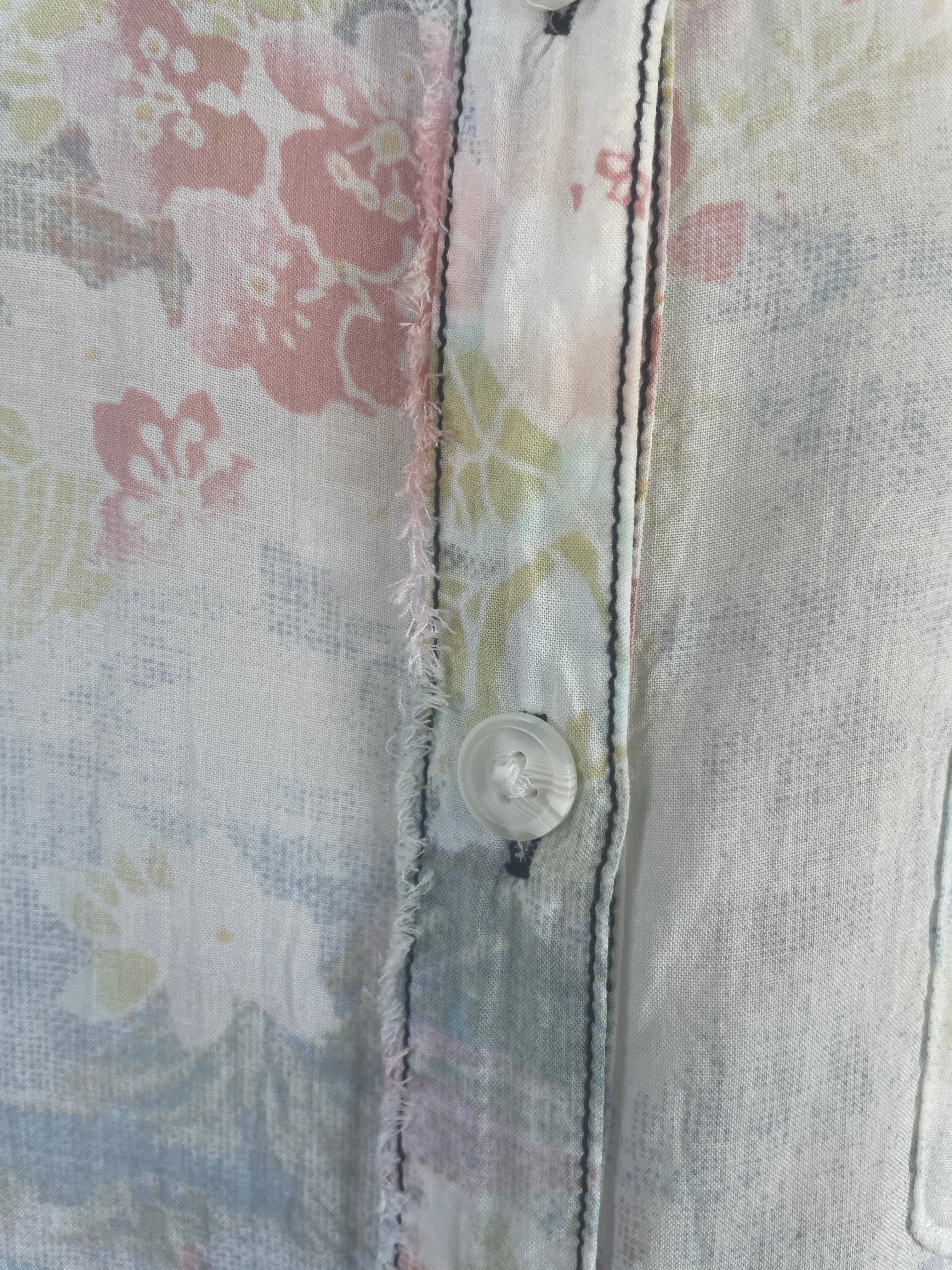 Oversized We The Free pastel floral shirt with raw seams, shown from detail close-up.
