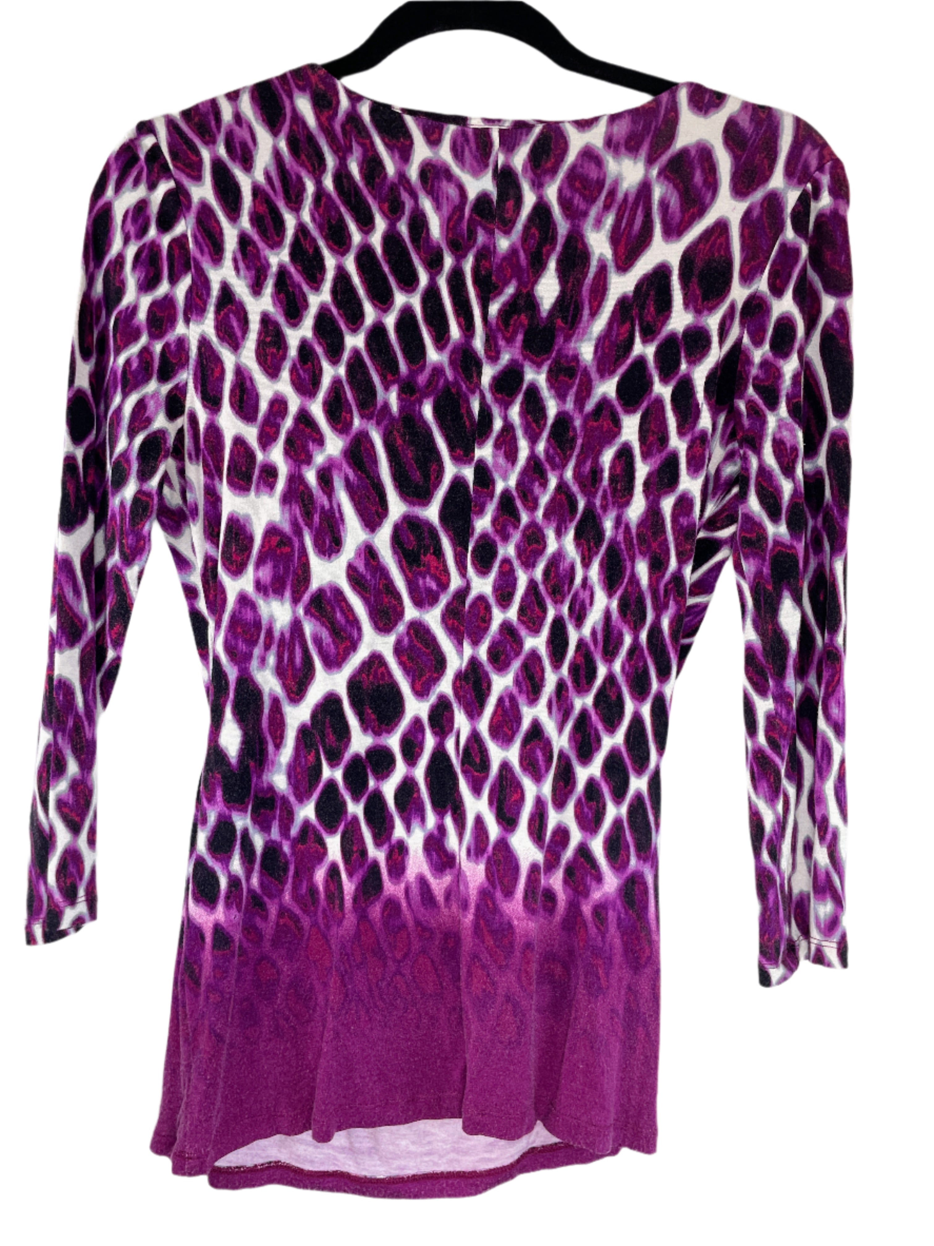 Purple and black patterned top on a hanger against a white background