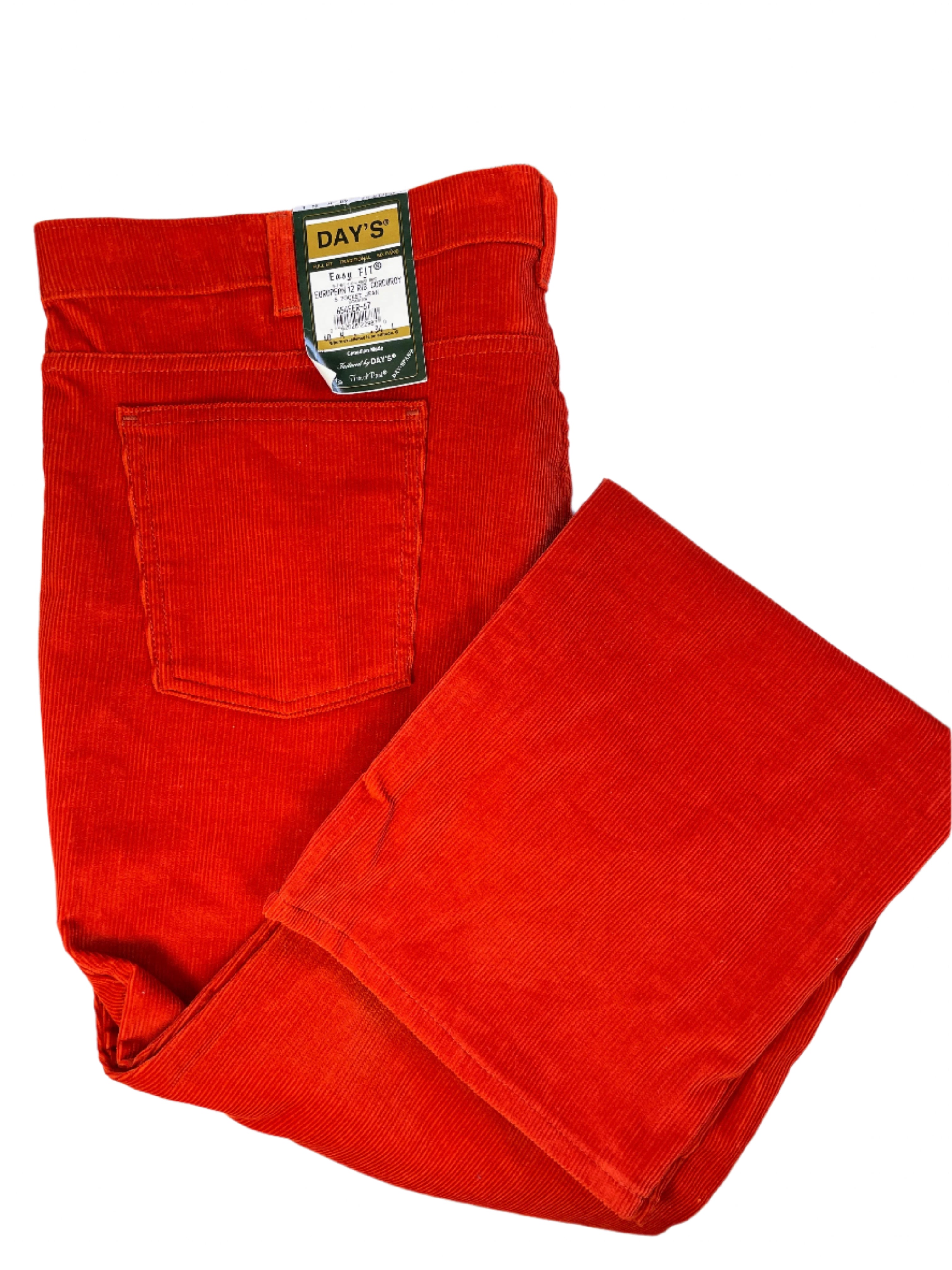 Red corduroy pants with a 'Day's' label on a white surface.
