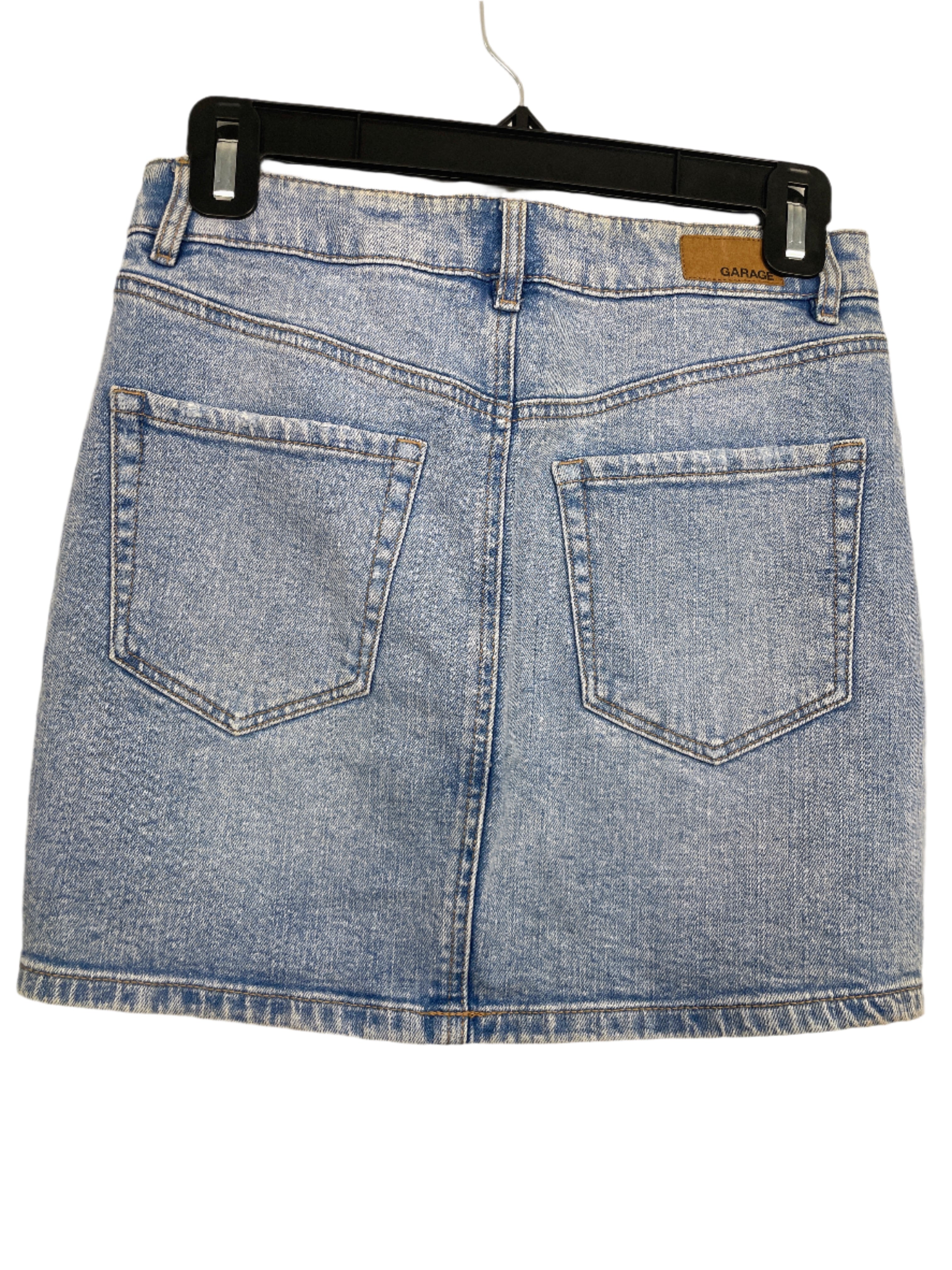 back view of Garage light wash denim mini skirt, size small, with distressed details and five-pocket style.