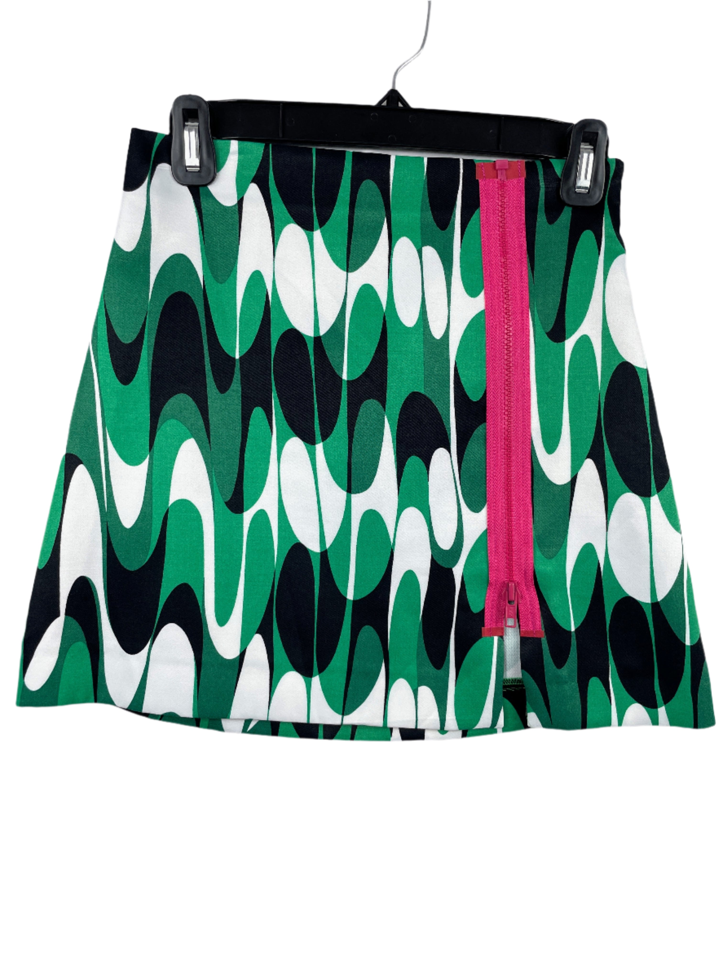 Zara green abstract mini skirt with decorative pink front zipper, size XS, laid flat front views.