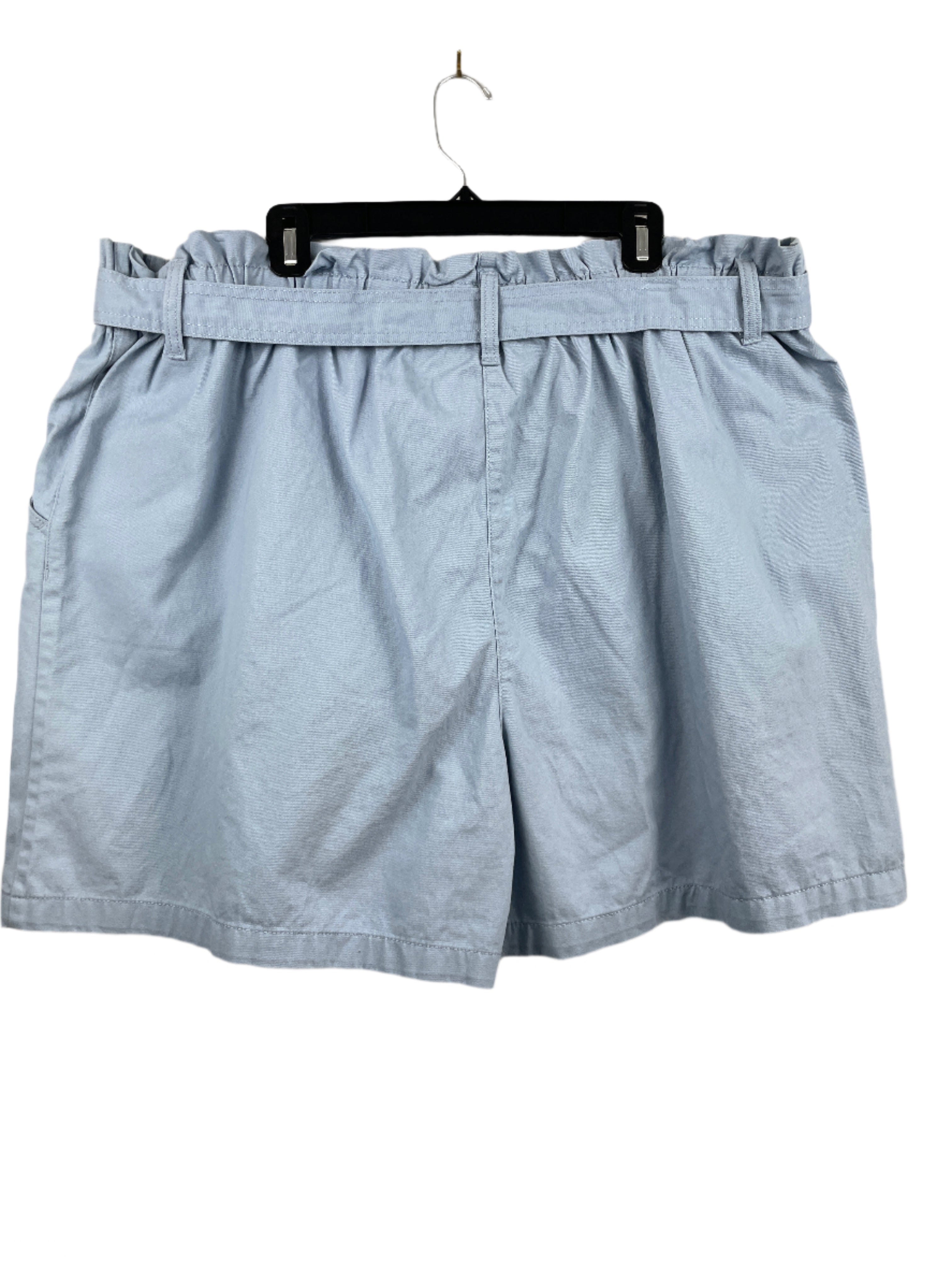 Light blue shorts on a hanger against a plain background