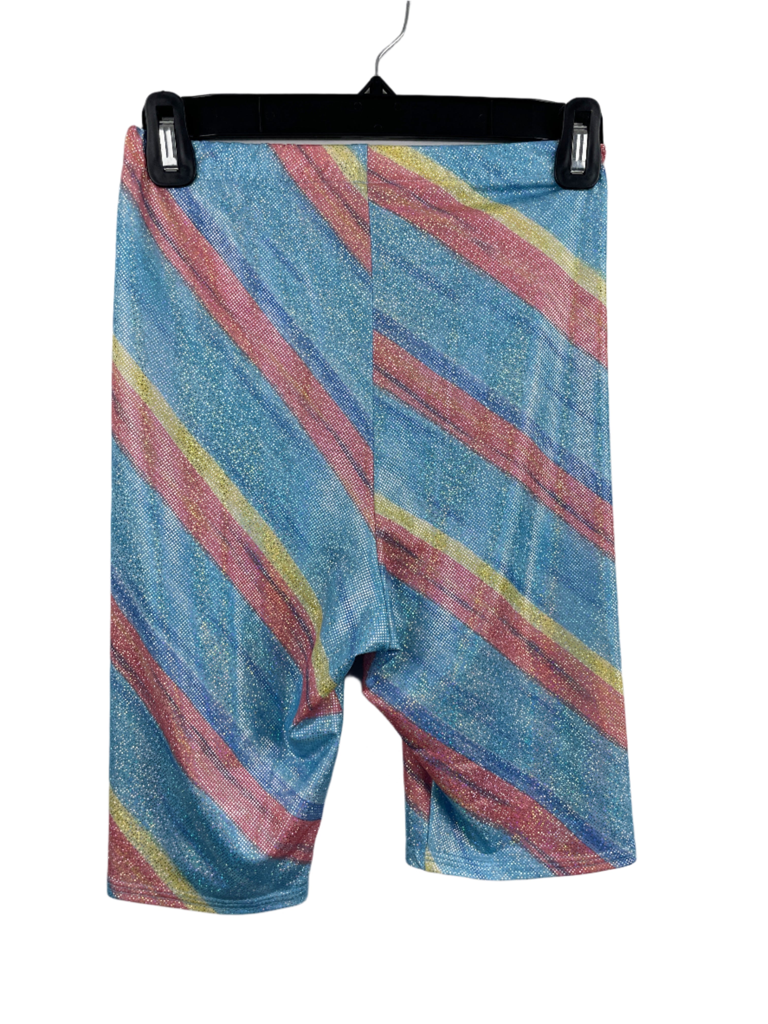 Front view of sparkly striped XXS biker shorts with rainbow glitter pattern on blue background, elastic waistband, mid-thigh length.