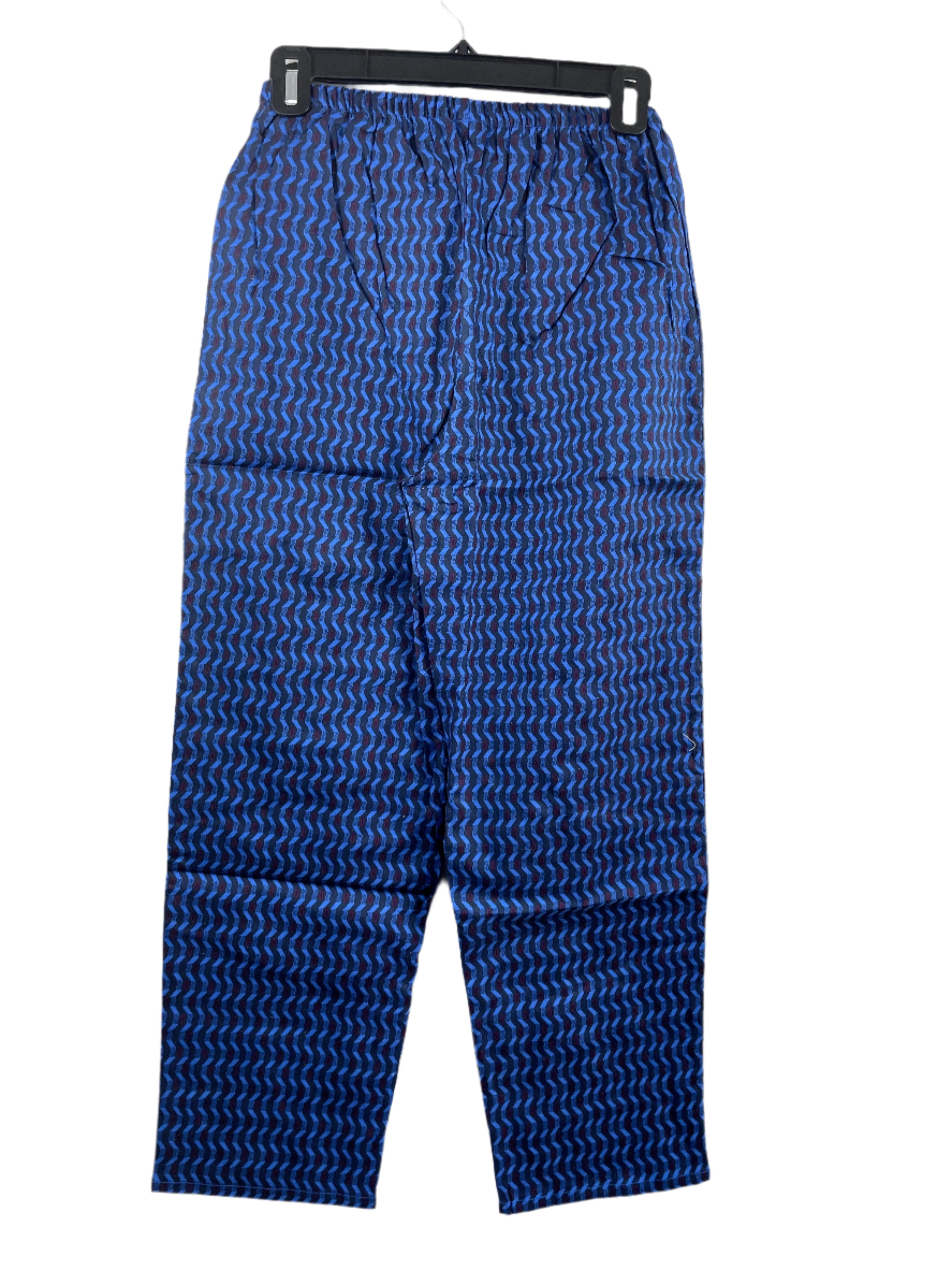 Blue patterned pyjama pants on a hanger against a white background