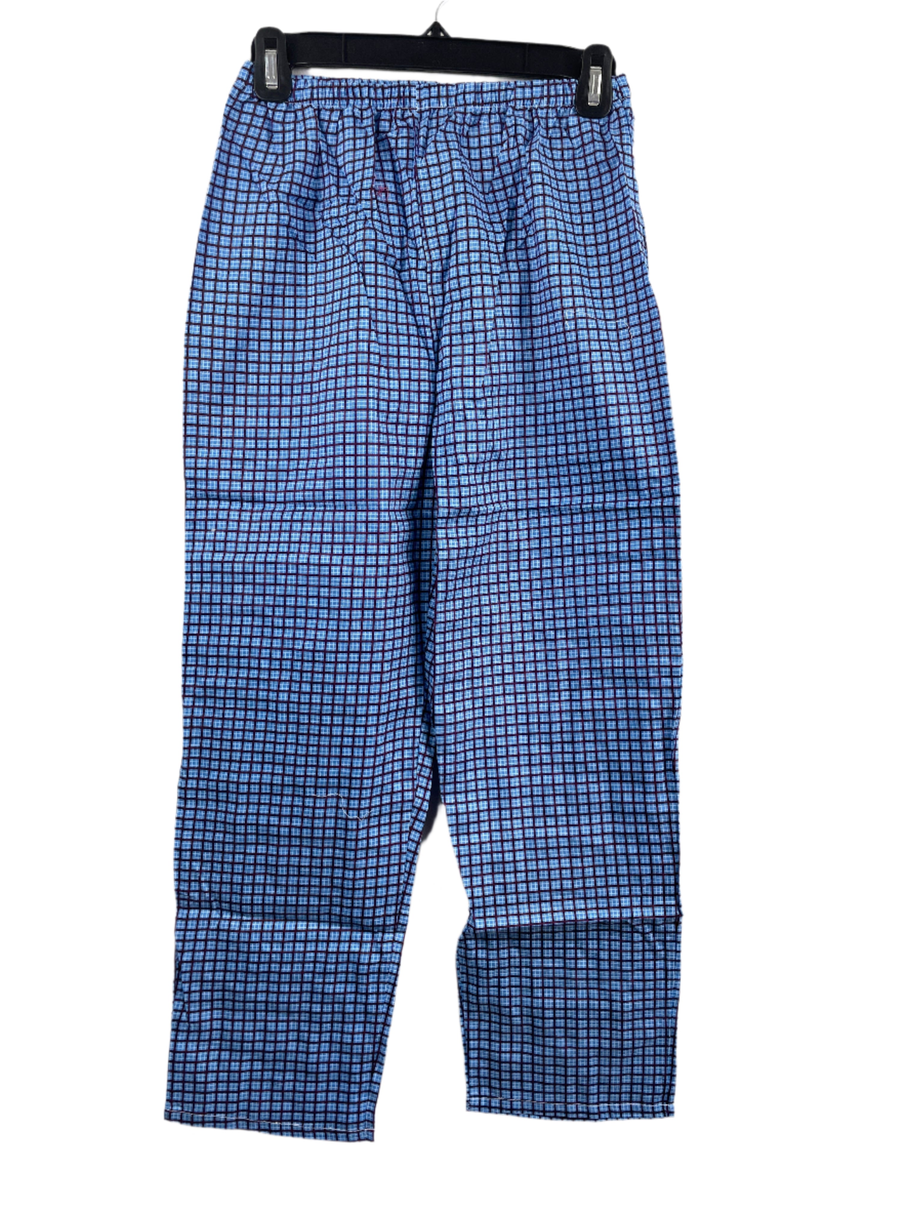 Blue checkered pyjama pants hanging on a white background