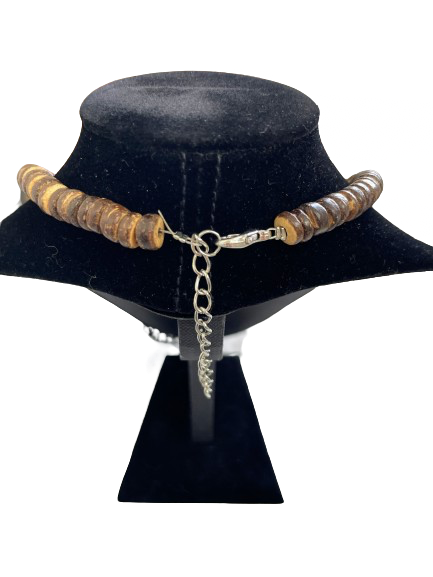 Necklace with brown beads on a black velvet stand against a white background
