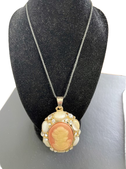 Cameo pendant necklace on a black bust