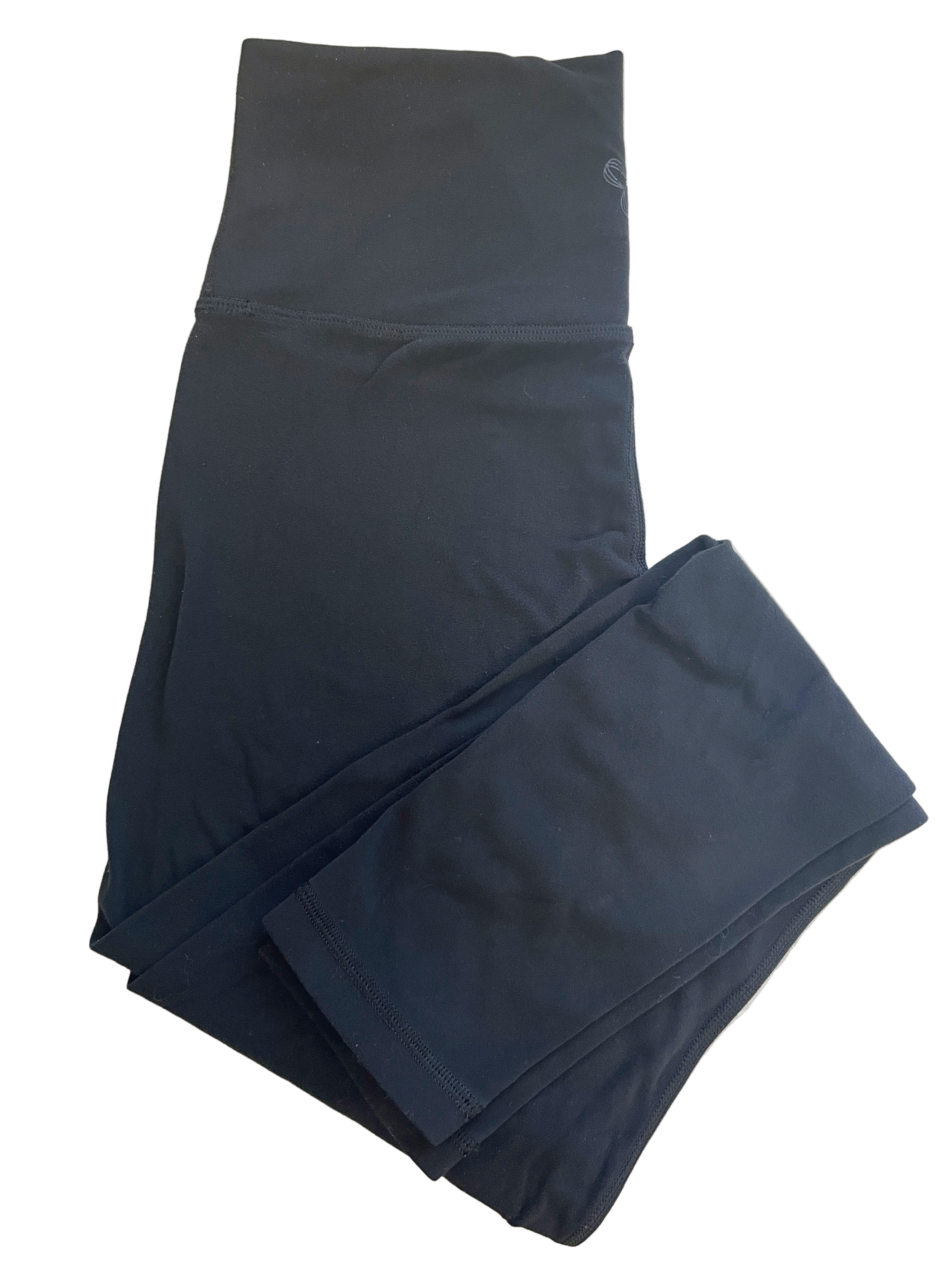 Folded view of Aritzia TNA black leggings with wide waistband