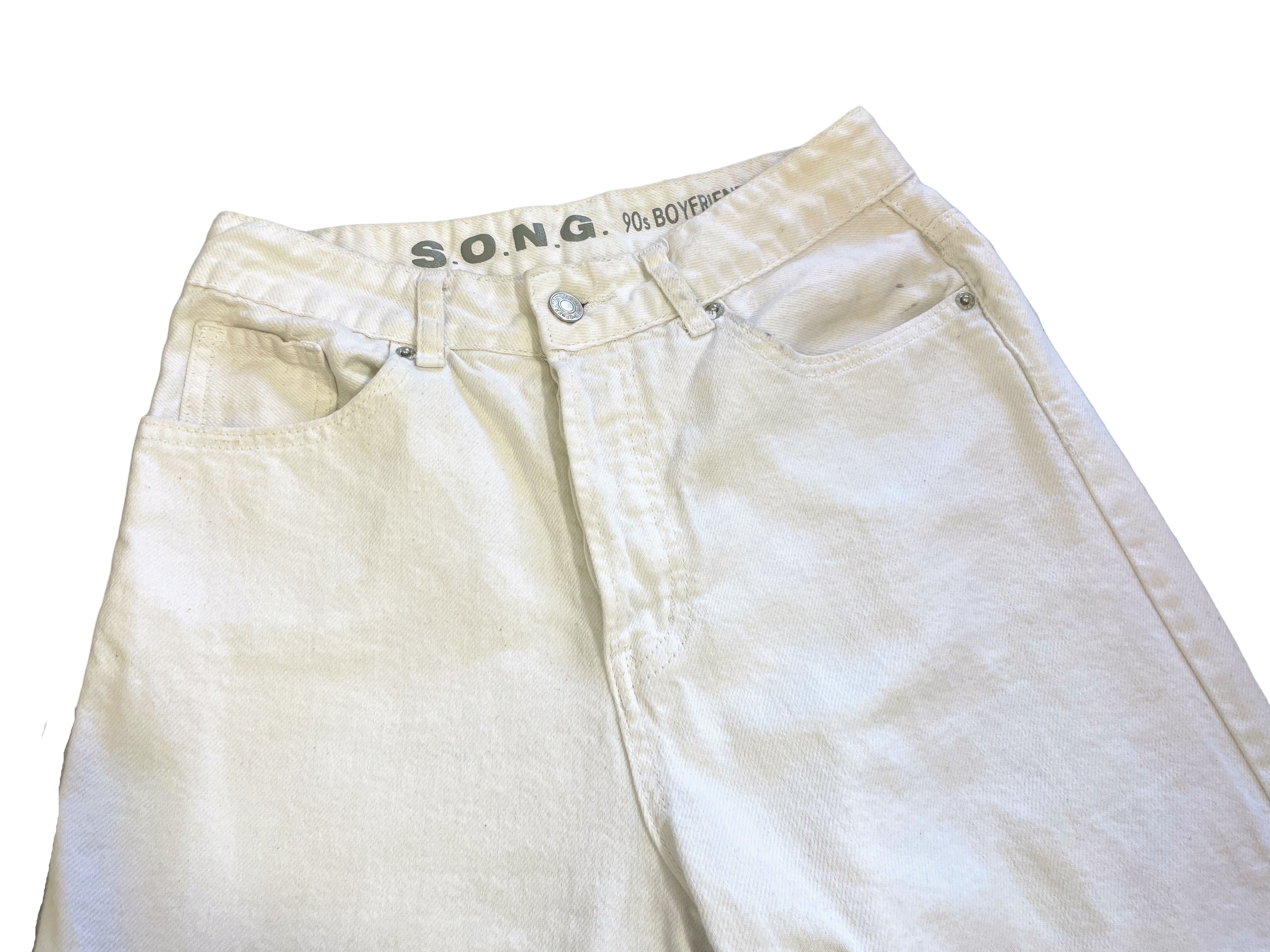 Light-colored pants with 'SONG' branding on a white surface.