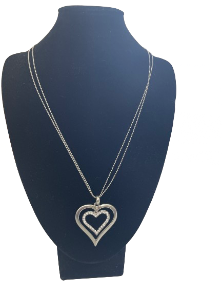 Necklace with a heart-shaped pendant on a mannequin bust against a white background
