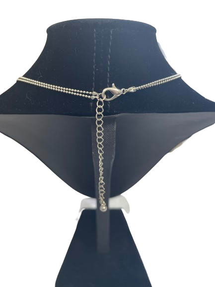 Silver chain necklace on a black mannequin bust