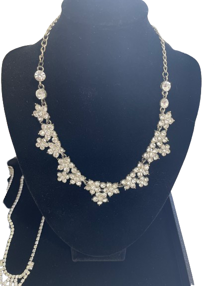 Elegant necklace with floral design on a mannequin bust against a white background