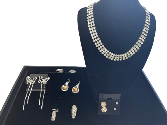 Jewelry set including a necklace, earrings, and rings displayed on a mannequin bust and tray.