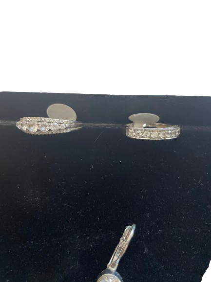 Diamond ring on a black stand with a small tool next to it