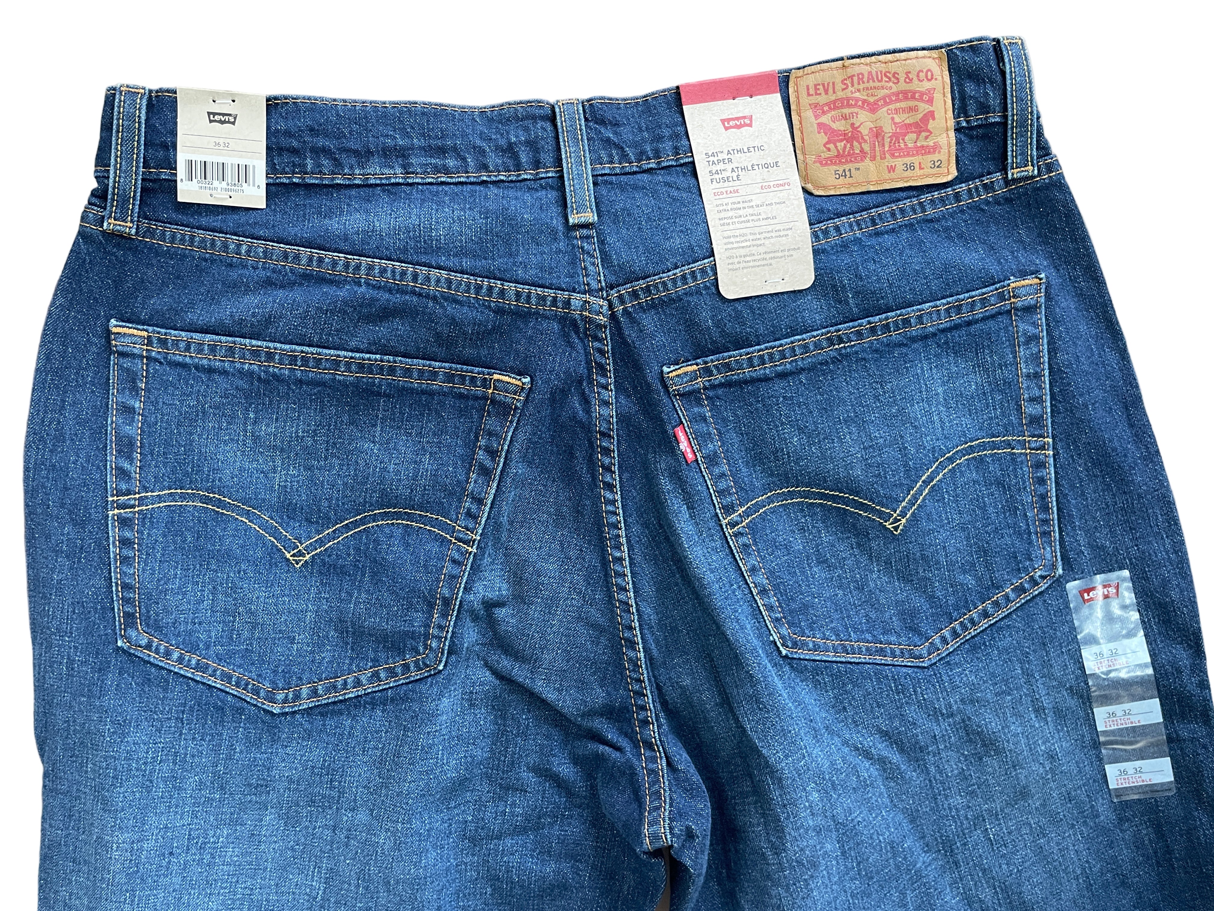Levi's jeans with tags on a plain background